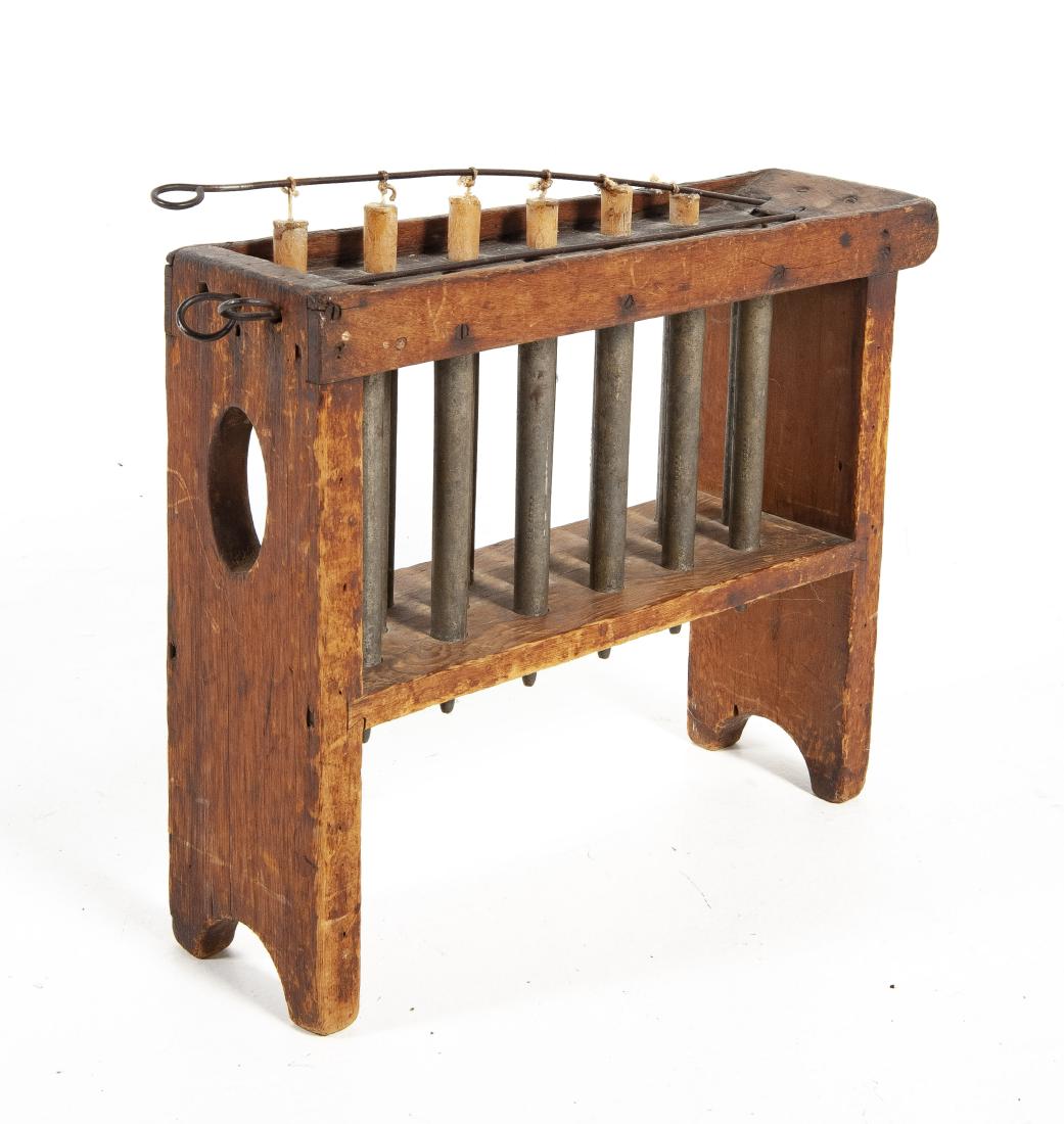 Bench Style Candle Mold: DESCRIPTION: Bench style candle mold. Eighteen candle capacity. Wood frame with brass molds and dovetail joints. Molds stamped "W. Webb NY". MEASUREMENTS: 21-3/4" x 6" x 7-1/2". CONDITION: Surface wea