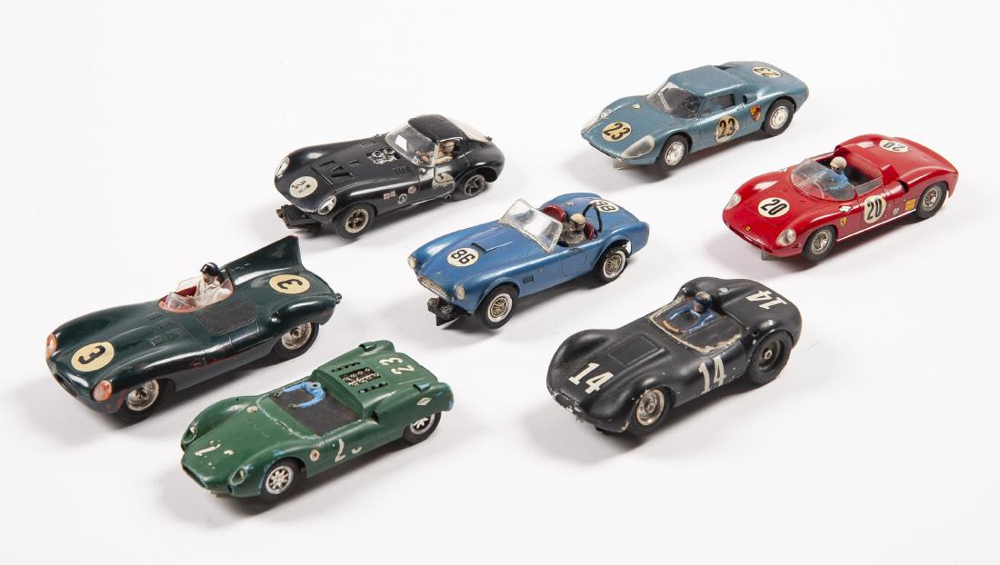 Seven 1/32 Scale Slot Cars: DESCRIPTION: Seven 1/32 scale slot cars. Includes Cox Cheetah, Monogram Ferrari Prova, Porsche, green #23, green #3, black #14, and blue #86. MEASURMENTS: 1/32 scale. CONIDTION: Each has been run with
