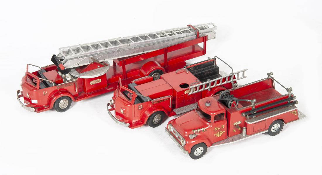 3 Pressed Steel Fire Trucks Incl Doepke: DESCRIPTION: Three pressed steel fire truck toys. Includes: 1) T.F.D. fire truck No. 5 by Tonka Toys. 2) Two Rossmoyne fire trucks by Doepke Model Toys. One with extension ladder. MEASUREMENTS: Ranges