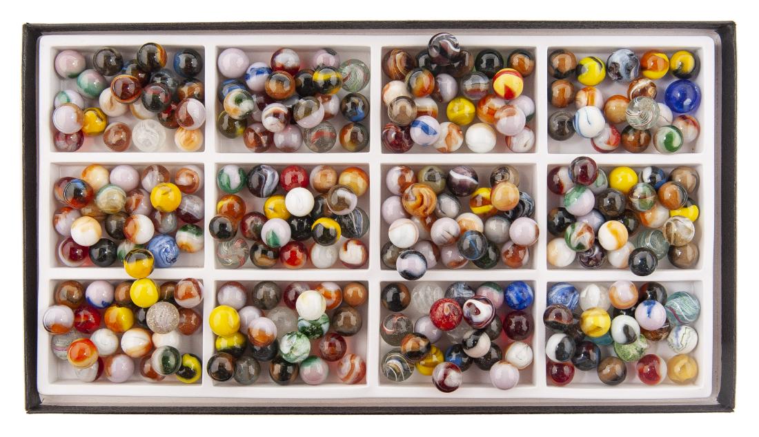 300 Hand and Machine Made Marbles: DESCRIPTION: 300 handmade and machine made marbles. Includes swirls, akro, vitro, slags, striped, patches, and more. MEASUREMENTS: Each approximately 1/2". CONIDITON: Older marbles bruised.