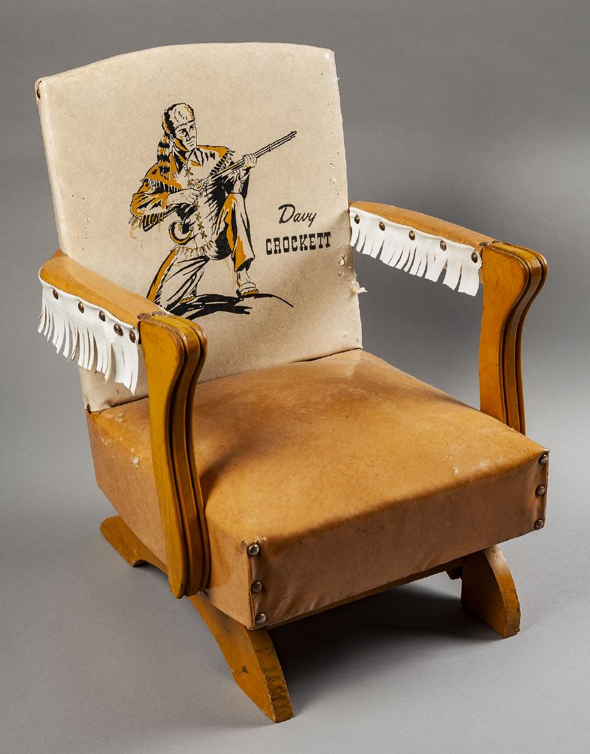 Davy Crockett Child's Rocking Chair: DESCRIPTION: Davy Crockett child's rocking chair. Vinyl cushions on wood frame. MEASUREMENTS: 17" wide x 17" deep x 23" high. CONDITION: Areas of wear to vinyl, especially at edges.