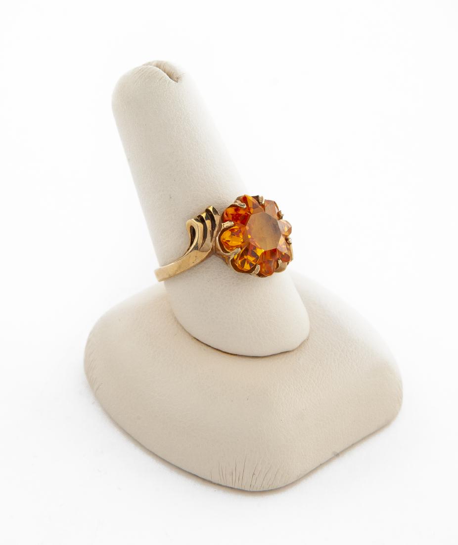 10K Orange Ring: DESCRIPTION: 10k ring set with simulated orange garnet. MEASUREMENTS: 2.9 dwt (4.5 gr). Size 8. CONDITION: Very light wear.