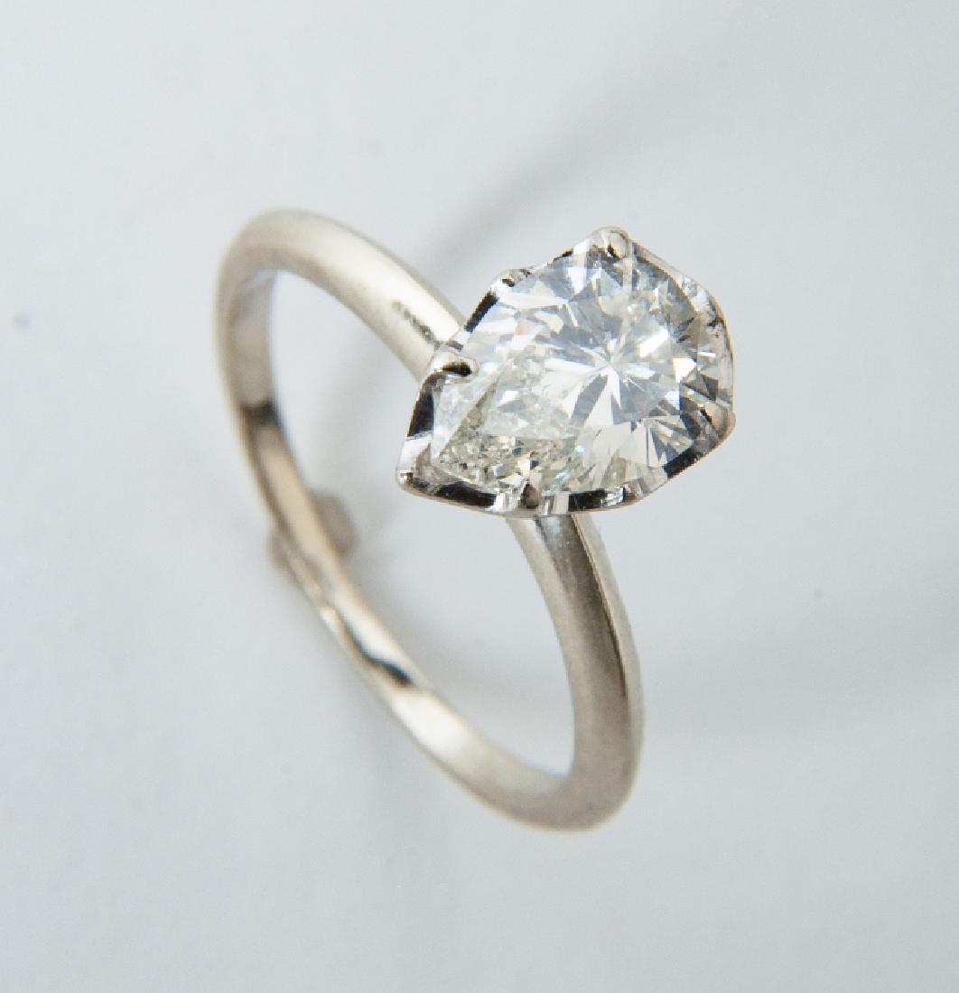 14k 1.36 Carat Pear Cut Diamond Solitaire: DESCRIPTION: 14k white gold setting with 1.36 carat pear shaped diamond (Clarity SI2, Color J-K). MEASUREMENTS: 1.5 dwt (2.3 gr). Size 6.5. CONDITION: Good. Appraised at 4,560 (Appraisal included).