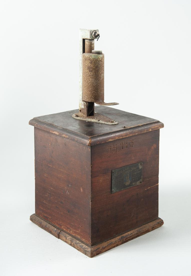 Midland Jump Spark Cigar Lighter: DESCRIPTION: Midland Jump Spark cigar lighter. In wood case with original varnish finish and stamped brass label reading "Midland Jump Spark / Cigar Lighter / U.S. & Canadian Patents / July 20, 1906 /