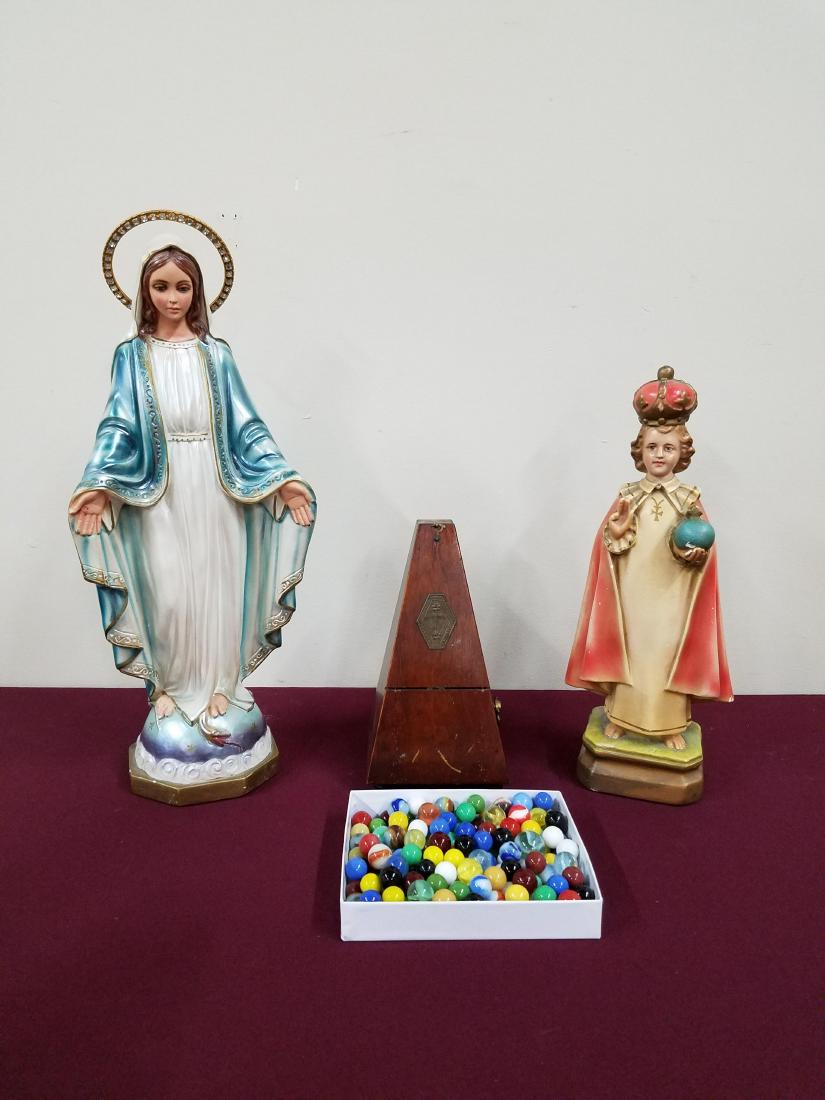 4 Pcs metronome, religious sculptures, and marbles: Some chips to religious sculptures. Tallest sculpture 17-1/2 high.