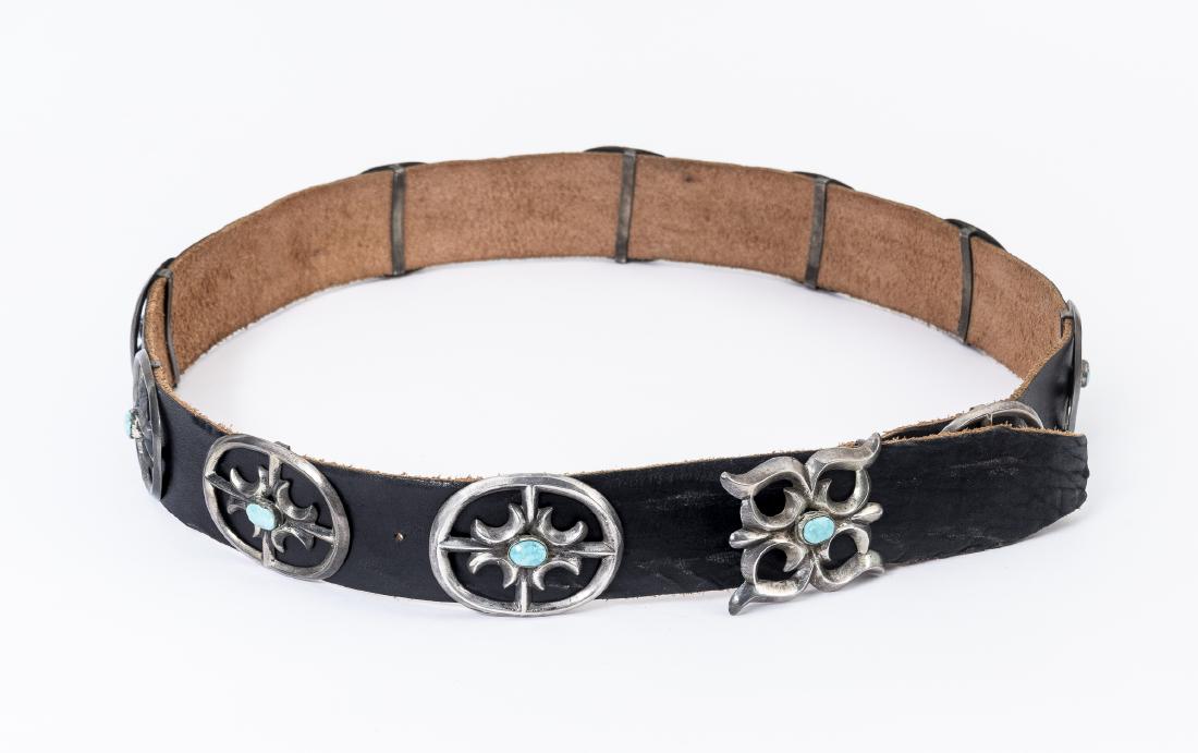 Leather Silver and Turquoise Concho Belt: DESCRIPTION: Leather belt with ten silver conchos, plus buckle, set with oval turquoise stones. MEASUREMENTS: 46" long. Buckle 2-1/2"x 2". Each concho 2-1/2"x 2". CONDITION: Softness to leather, wear 