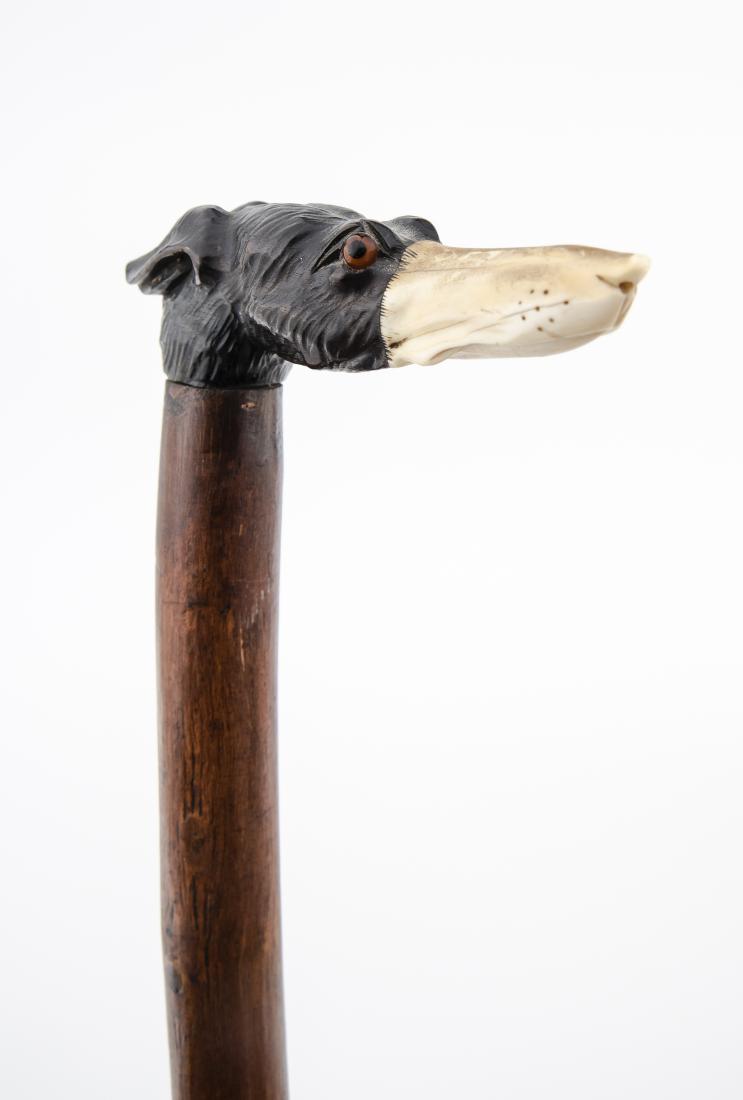 Carved Bone & Wood Cane: DESCRIPTION: Carved bone and wood walking stick or cane. 19th century. Carved wood and bone dog head handle with smooth wood shaft and brass ferrule. No collar. Dog with glass eyes. MEASUREMENTS: 33-1