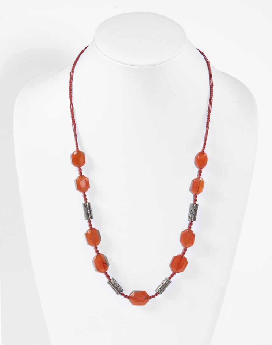 Carnelian and Silver Necklace: DESCRIPTION: Necklace with silver beads and hexagonal carnelian stones on orange woven thread. MEASUREMENTS: 27" long. CONDITION: Light wear.