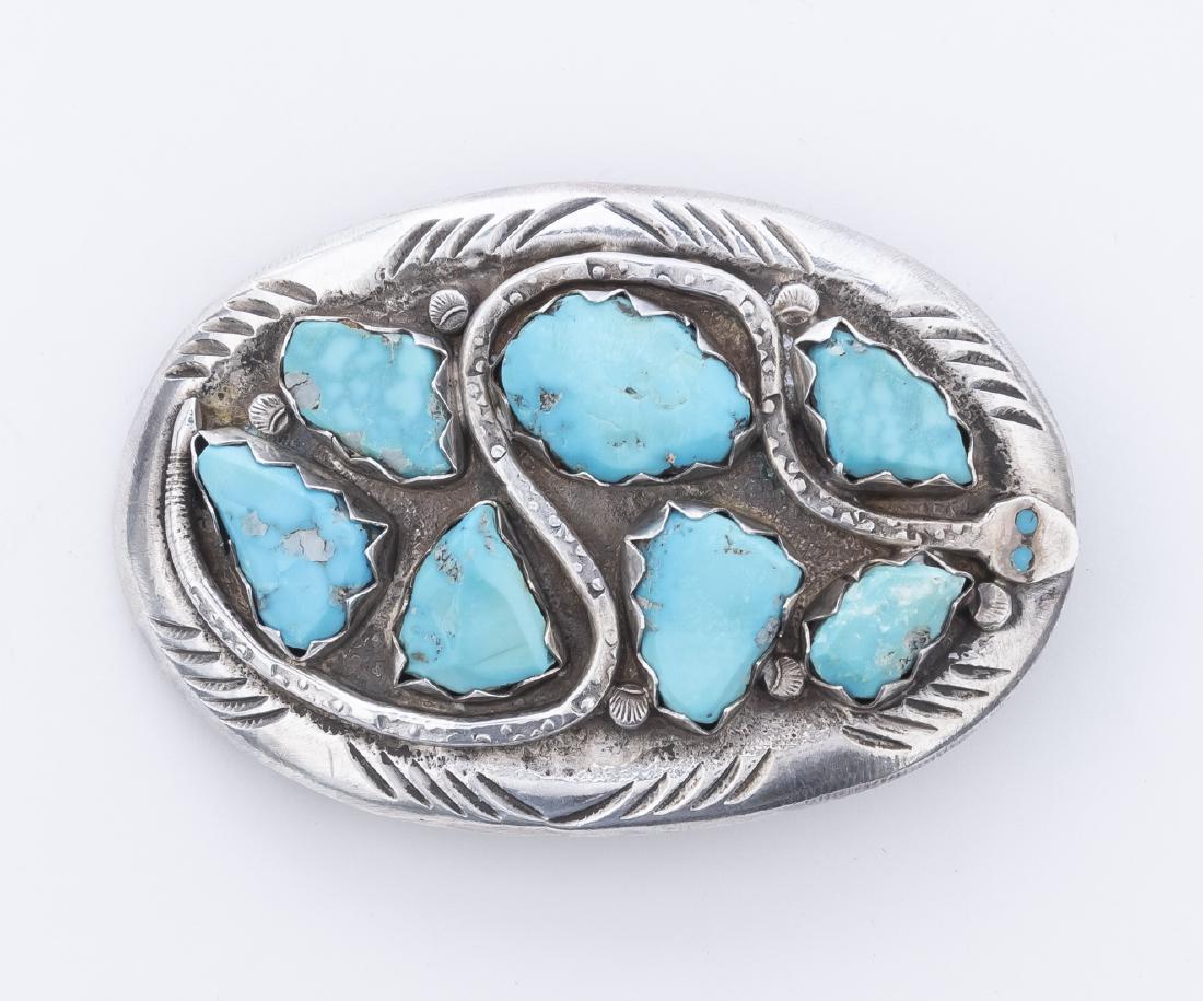 Turquoise and Silver Belt Buckle: With serpent design. Marked on reverse "Effie C. Zuni". 2-1/2" x 3-3/8".