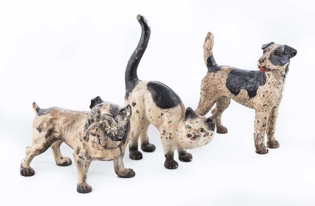 3 Cast Iron Animal Doorstops: DESCRIPTION: Three cast iron animal doorstops. Includes Bulldog, Hubley cat, and Terrier. MEASUREMENTS: Each approximately 15" x 10". CONDITION: Paint appears original. Wear to paint as expected with 