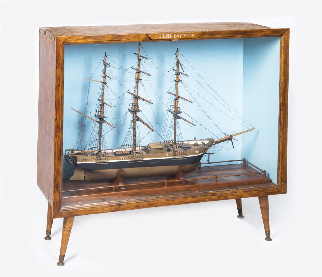 Golden Bay Clipper Model Ship in Display Cabinet: DESCRIPTION: Golden Bay Clipper model ship in floor display cabinet stand. Built by Melvin (Sonny) Huntsinger, Nov. 1969 - Mar. 1970. Three mast ship with taut-lines and hand painted details. MEASUREM