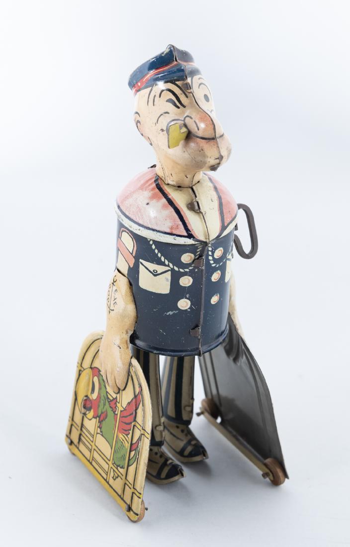 Marx Popeye with Parrots Wind up Toy: DESCRIPTION: Marx Popeye wind up tin litho toy. With parrot in cage in each hand. MEASUREMENT: 8-1/4". CONDITION: Minor areas of paint loss. Works.