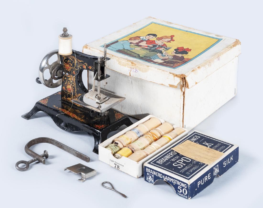 Casige Child's Sewing Machine No. 28 in OB: DESCRIPTION: German Casige child's sewing maching in original box. No. 28. Plate marked "Made in Germany" with Casige logo. Includes box of ten Brainerd & Armstrong spools and three additional spools.