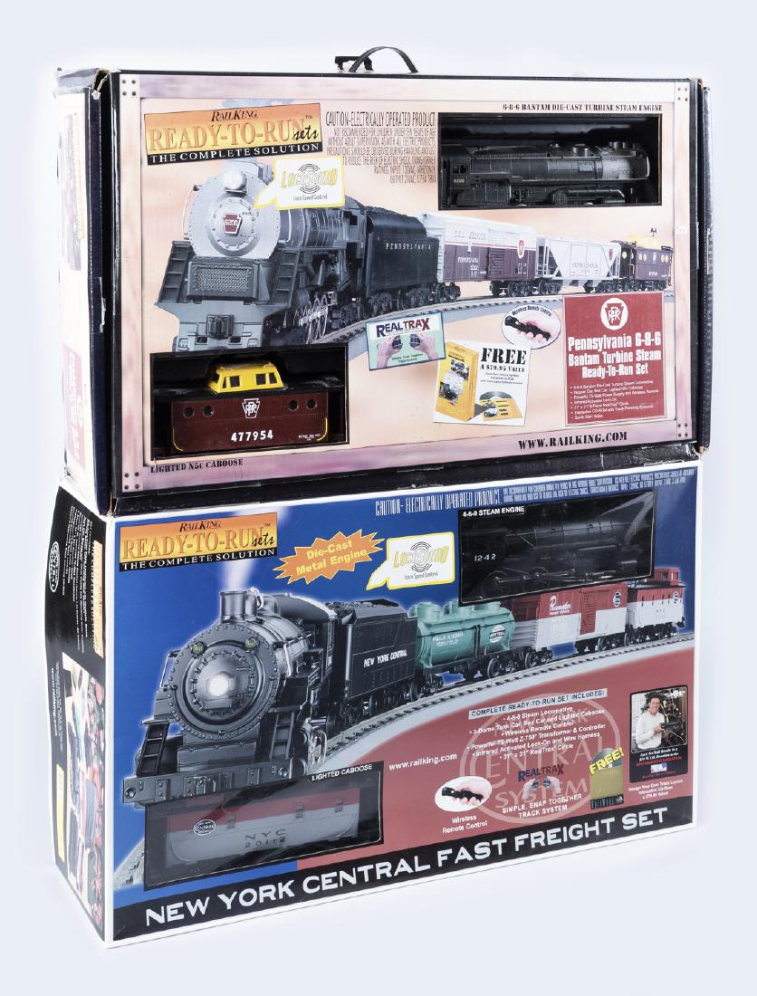 2 Rail King Ready-To-Run Train Sets in OBs: DESCRIPTION: Two Rail King O gauge ready-to-run train sets in original boxes. Includes 30-4046-0 New York Central 4-6-0 Steam R-T-R train set with loco-sound and 30-4056-0 Pennsylvania 6-8-6 Bantan Tu