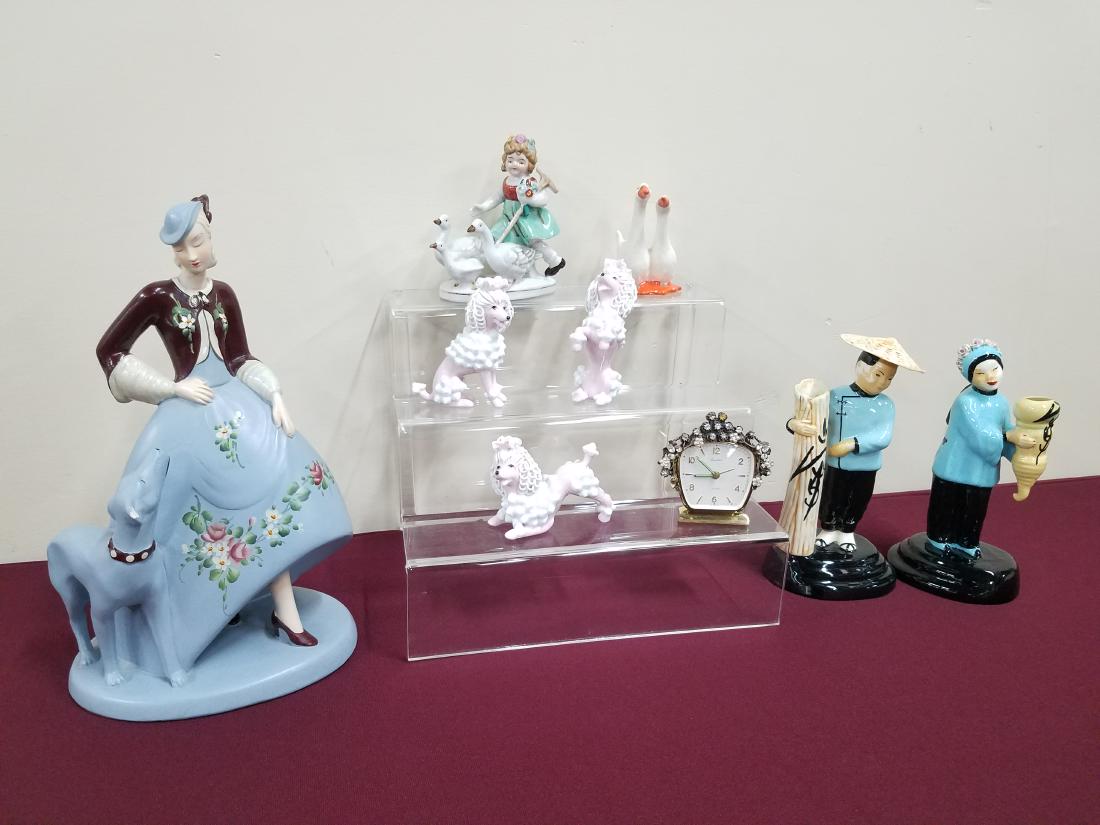 8 Figurines and Clock including Beswick: 3" to 13-1/2" high. Crazing and chips to girl with dog. Paint losses to Asian figures. Also includes Landau West Germany clock.