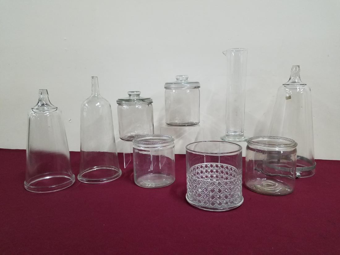 9 Apothecary Jars and Beakers: 5" to 14" high. Many "Factory of District N.C.". Jar lids with chips.