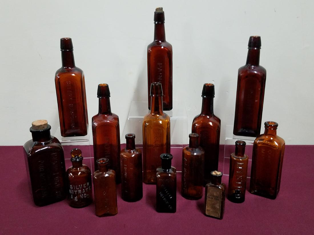 15 Apothecary Bottles: 4" to 10" high. Includes Paines, A.L. Murdock, Wallace & Teirman Co., Cabots, and Mckesson & Robbins Co.