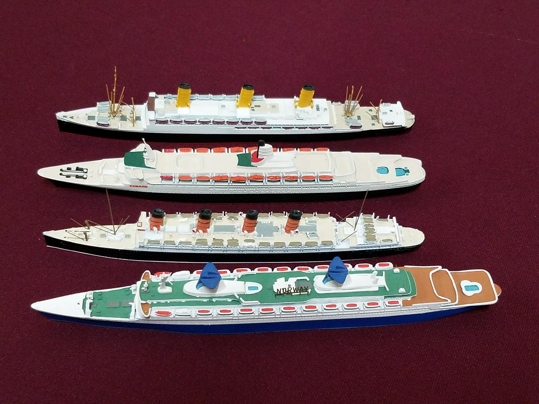 4 Miniature Cast Wiedling Ships: Made in Germany. Includes Cunard, Aquitaina, Mercator, and Vaterland. 8-1/2" to 10" long x 1-1/2" to 2" high.