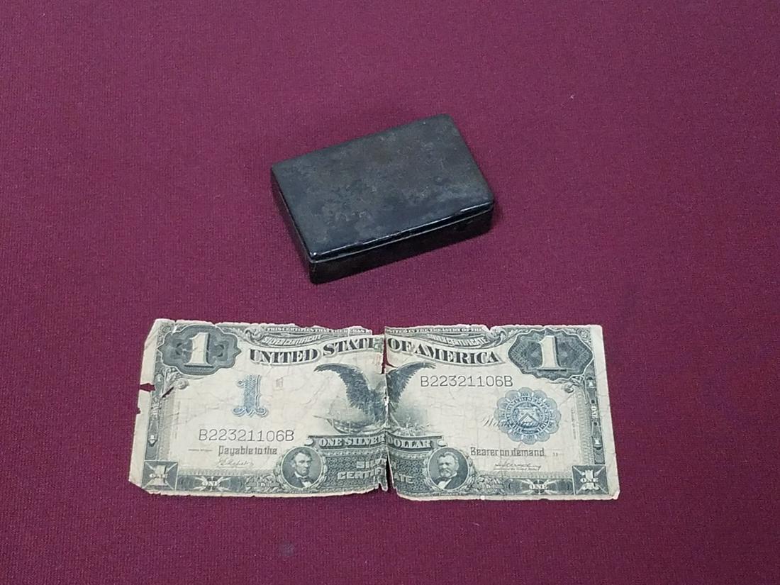 1899 $1 Silver Certificate and Snuff Box: Includes paper mache snuff box. Silver certificate from series of 1899 with tear at center and some losses.