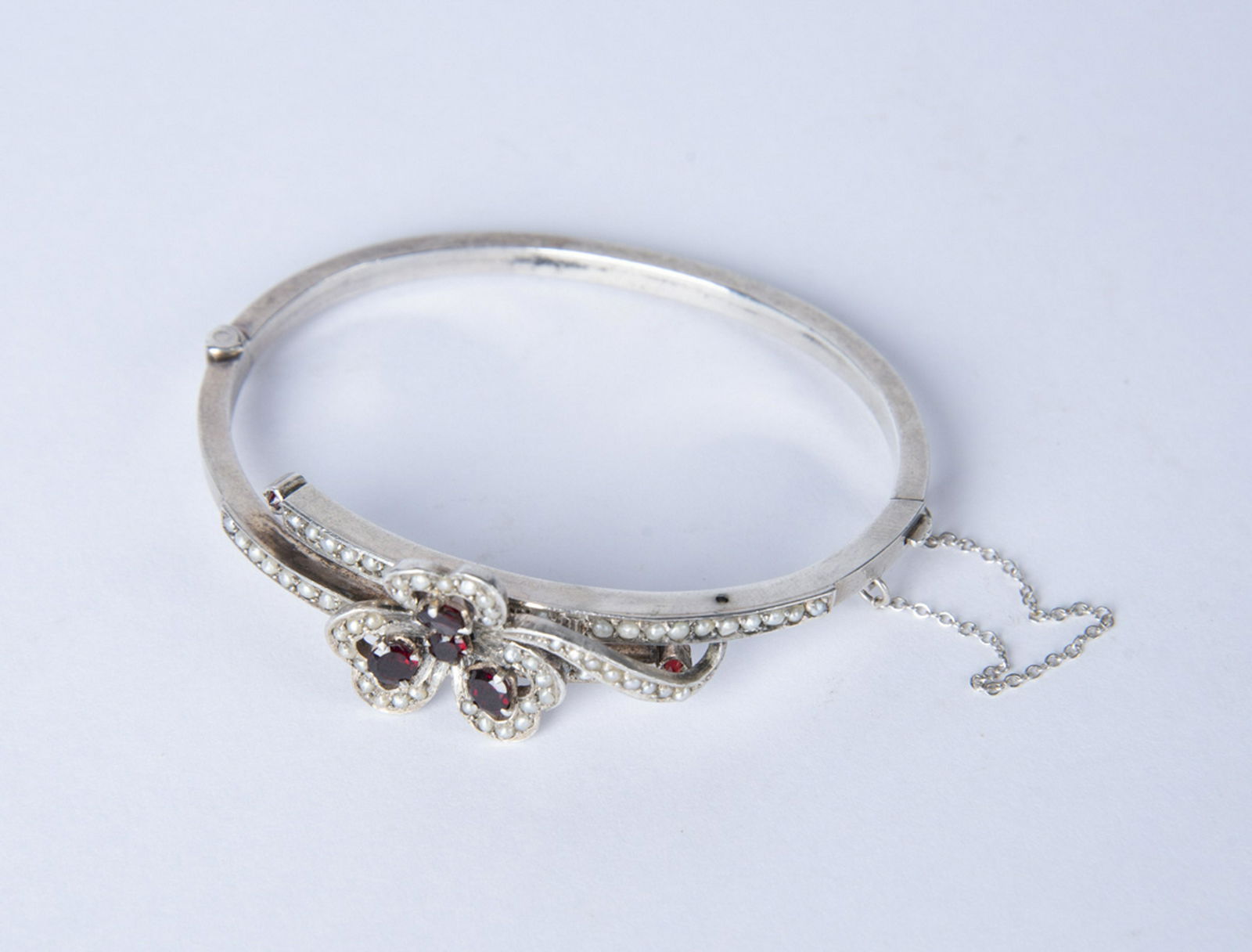 Silver Seed Pearl and Garnet Bracelet: DESCRIPTION: Seed pearl and garnet bracelet with safety chain and touch marks to clasp. Probably French. MEASUREMENTS: Interior 2-1/2". Top 3/4". CONDITION: Light wear. No missing pearls or stones.