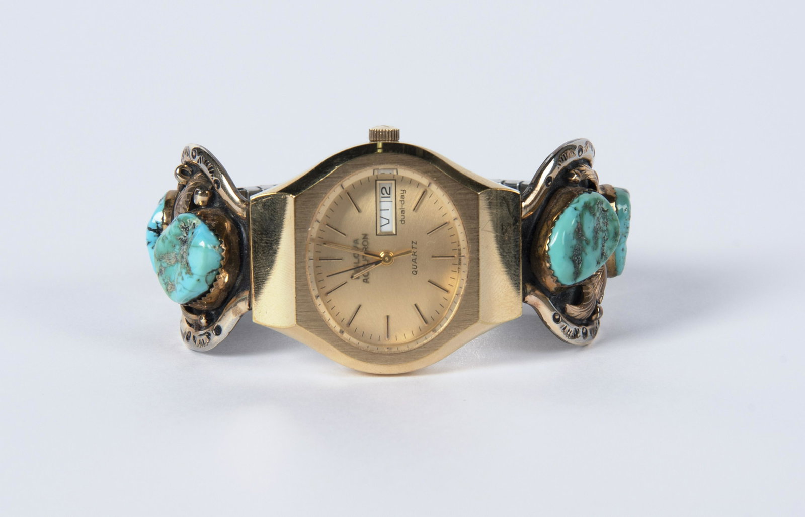 Kee Tsosie Sterling & Turquoise Watch Band: DESCRIPTION: Kee Tsosie sterling and turquoise watchband with leaf and turquoise design. Includes Bulova Accutron watch. MEASUREMENTS: 1-3/4" lug to lug. CONDITION: Light wear.