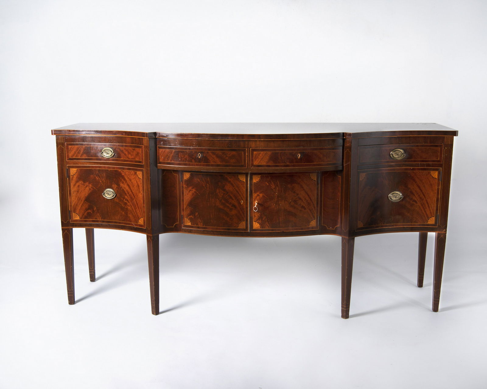 Federal Style bench Made Sidebaord: DESCRIPTION: Federal style bench made sideboard. Three drawers over two doors and to drawers. Flame mahogany with string and fan inlay. MEASUREMENTS: 104" w x 26" d x 39-1/2" h. CONDITION: Minor surfa