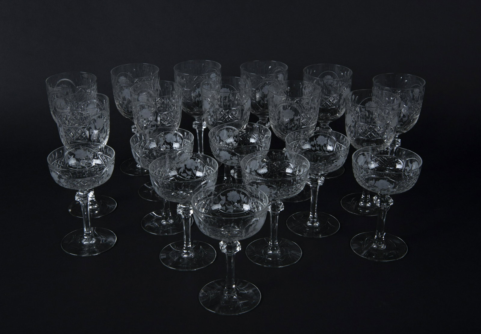 19 Pcs American Brilliant Cut Glass Stemware: DESCRIPTION: Nineteen pieces American Brilliant cut glass stemware with rose pattern. Unmarked. Includes eleven 7-1/4" wine coupes, and eight 5-1/2" champagne coupes. MEASUREMENTS: See description. CO