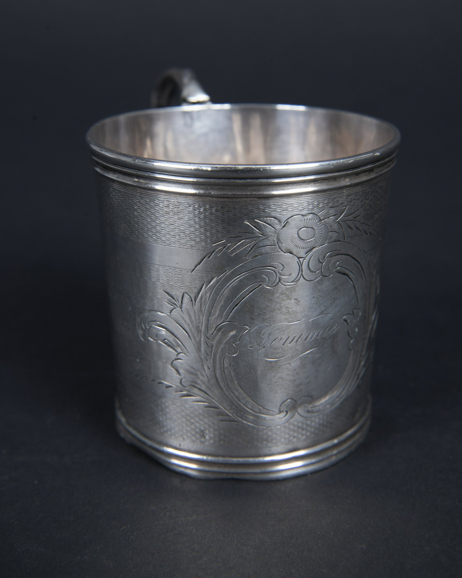 18/19th Century Sterling Christening Cup: DESCRIPTION: 18th or 19th Century sterling Christening cup. Engraved "Tommy". With three part hallmark. MEASUREMENTS: 2.4 ozt. 2-3/4" high. CONDITION: Repair to handle. Overall wear including dents an