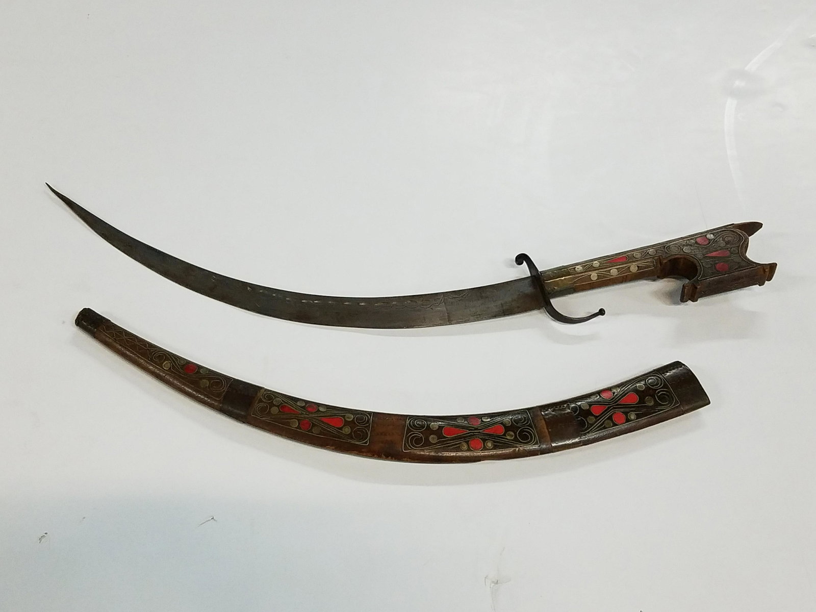 Middle Eastern Scimitar: 24-1/2" long. Inlaid wooden sheath.