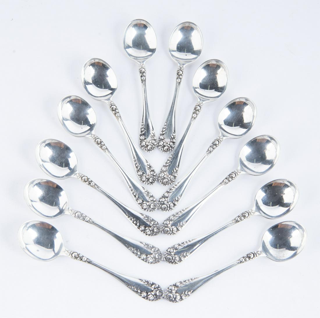 12 Sterling Wallace Rose Chocolate Spoons: DESCRIPTION: Twelve sterling Wallace large chocolate spoons in Rose pattern, circa 1898. Marked "Pat 1898 RW&S Sterling". MEASUREMENTS: 4.4 ozt total. 4" long. CONDITION: Light wear.
