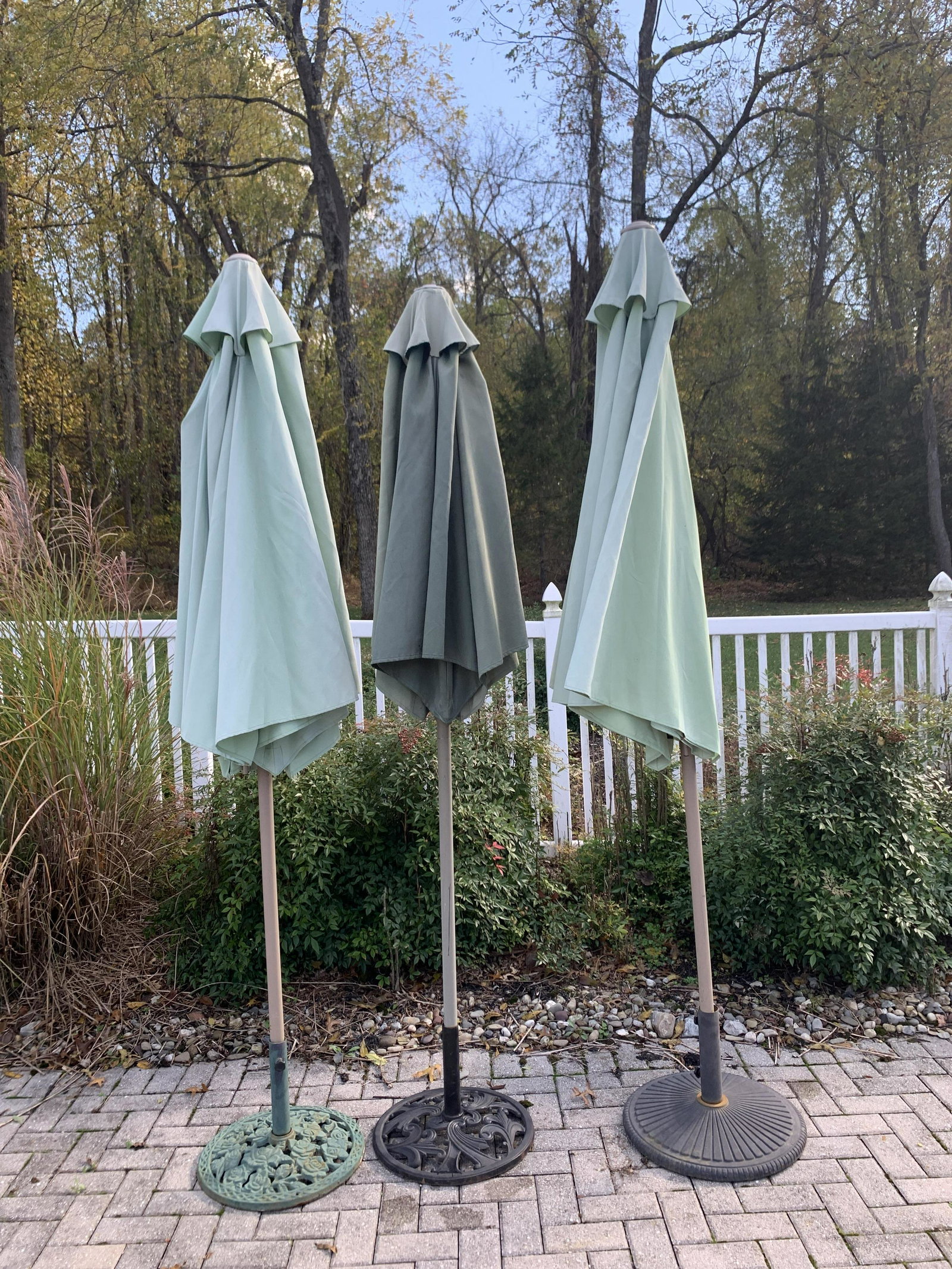 3 Green Patio Umbrellas with Metal Stands: 90" high. Discoloration to umbrella fabric.