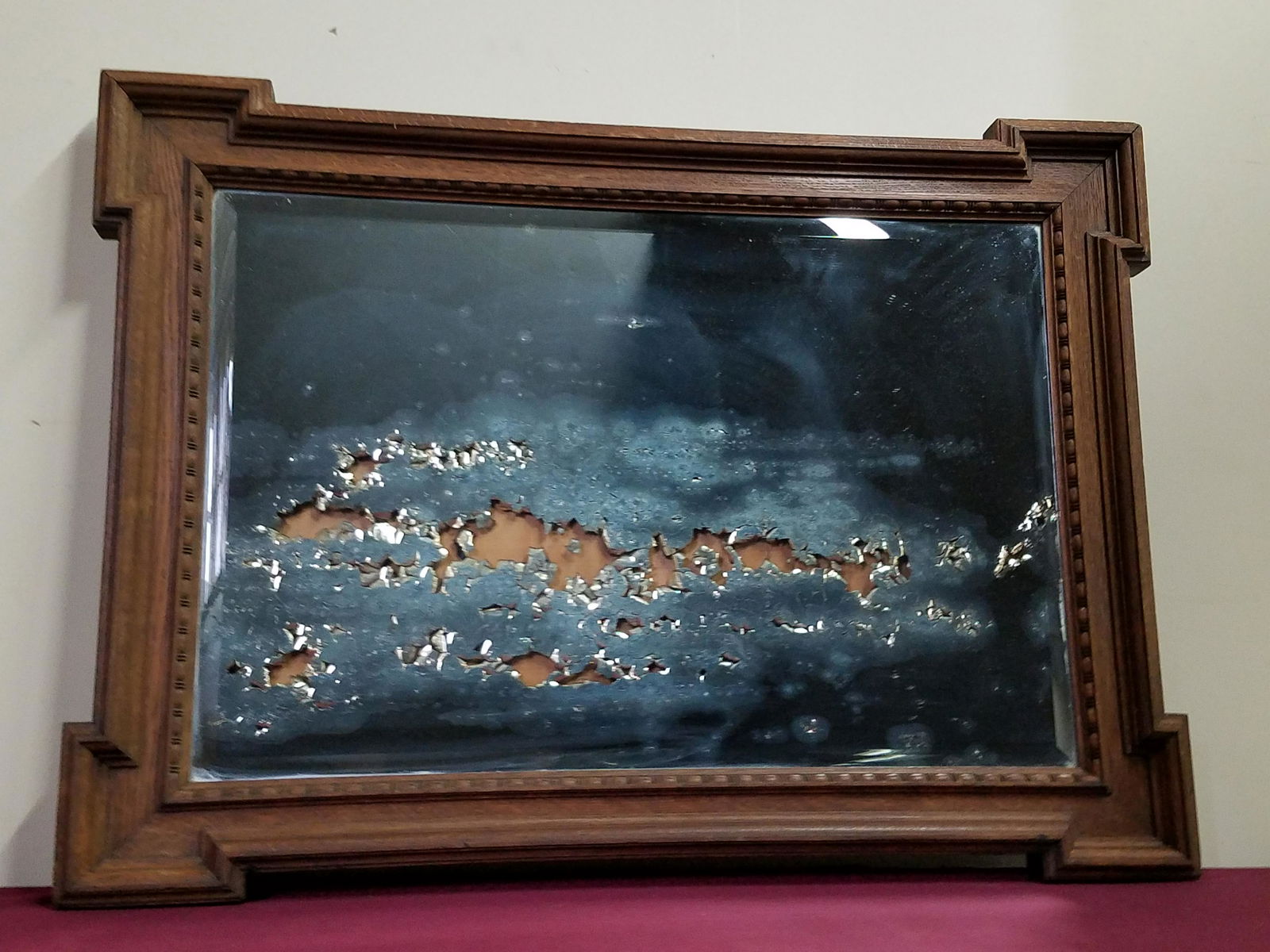 Antique Mirror: Mirror pealed from interior. Overall with frame 29-3/4" high x 40-1/2" wide.