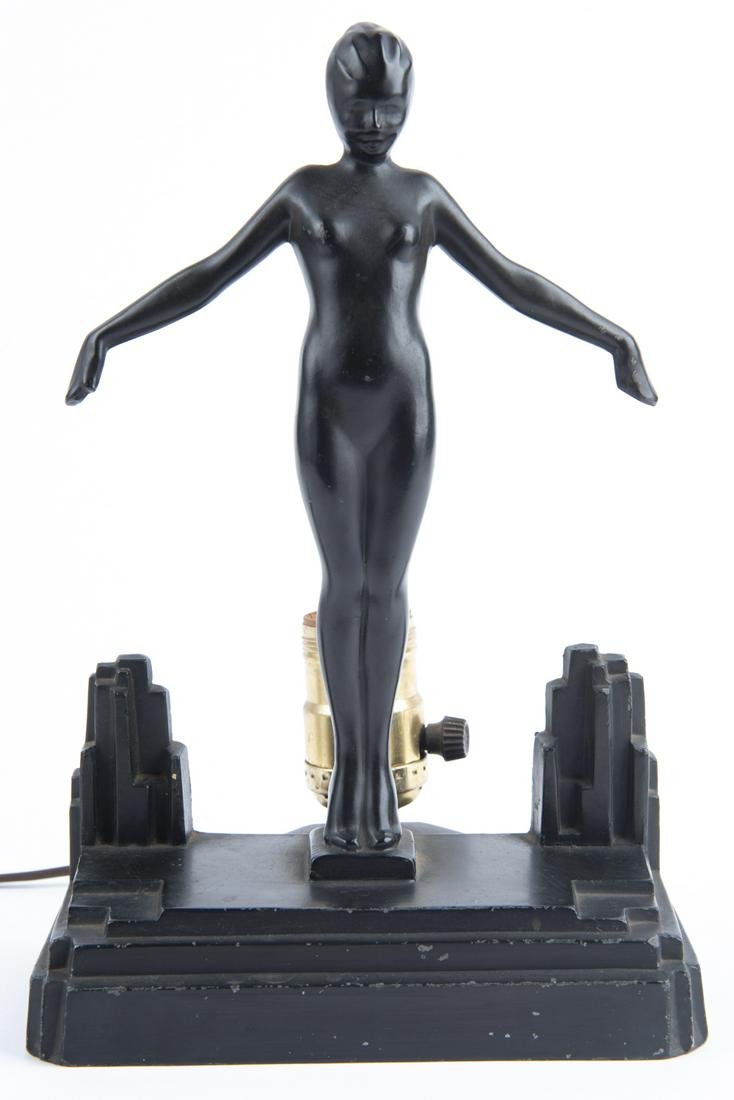 Frankart Female Nude Figural Table Lamp: DESCRIPTION: Frankart female nude figural table lamp. MEASUREMENTS: 6-1/2" x 5" x 9-3/4". CONDITION: Missing glass panel. Electric components replaced.