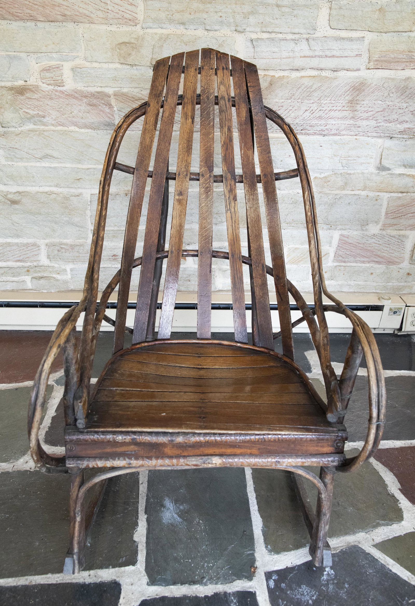 Adirondack Twig Rocker: DESCRIPTION: Adirondack twig rocker. MEASUREMENTS: 34-1/2" wide x 23-1/2" deep x 44" high. CONDITION: Very good. Light surface wear.