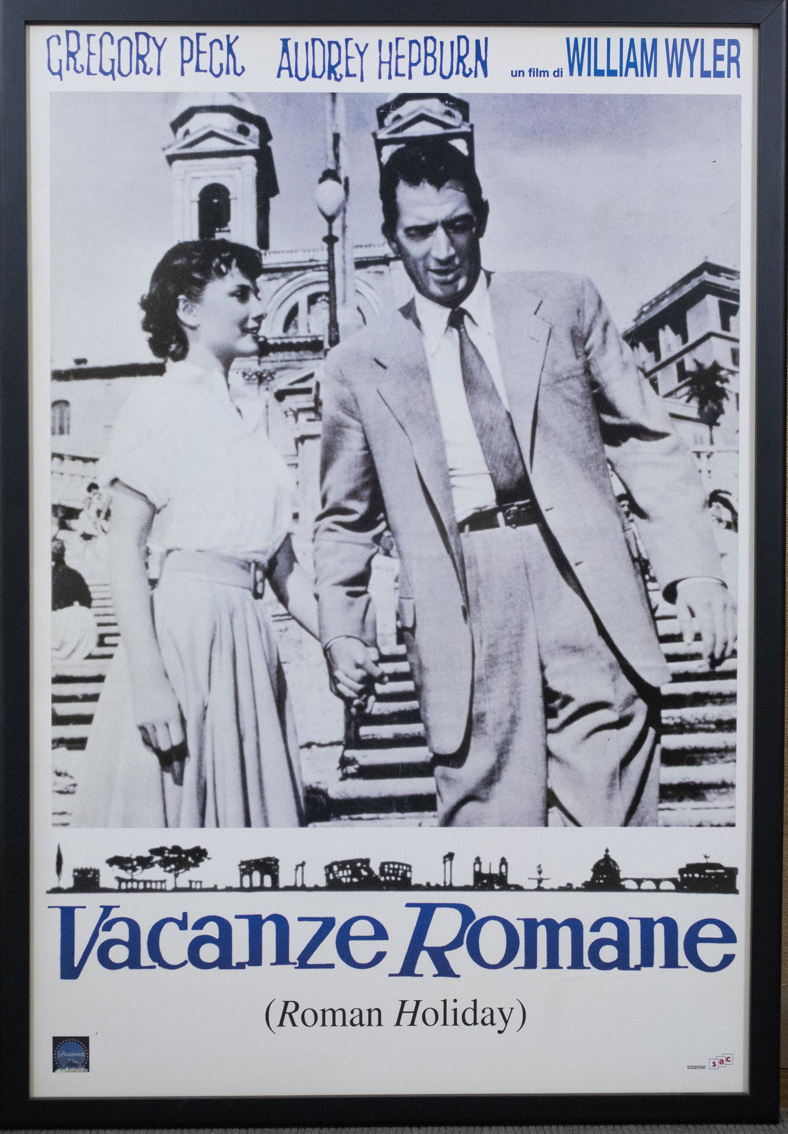 Italian Roman Holiday Movie Poster: DESCRIPTION: Italian "Vacanze Romane / Roman Holiday" movie poster. In black plastic frame. MEASUREMENTS: Sight 38-1/2" x 26". Overall with frame 41" x 28-1/2". CONDITION: Light rippling to paper.
