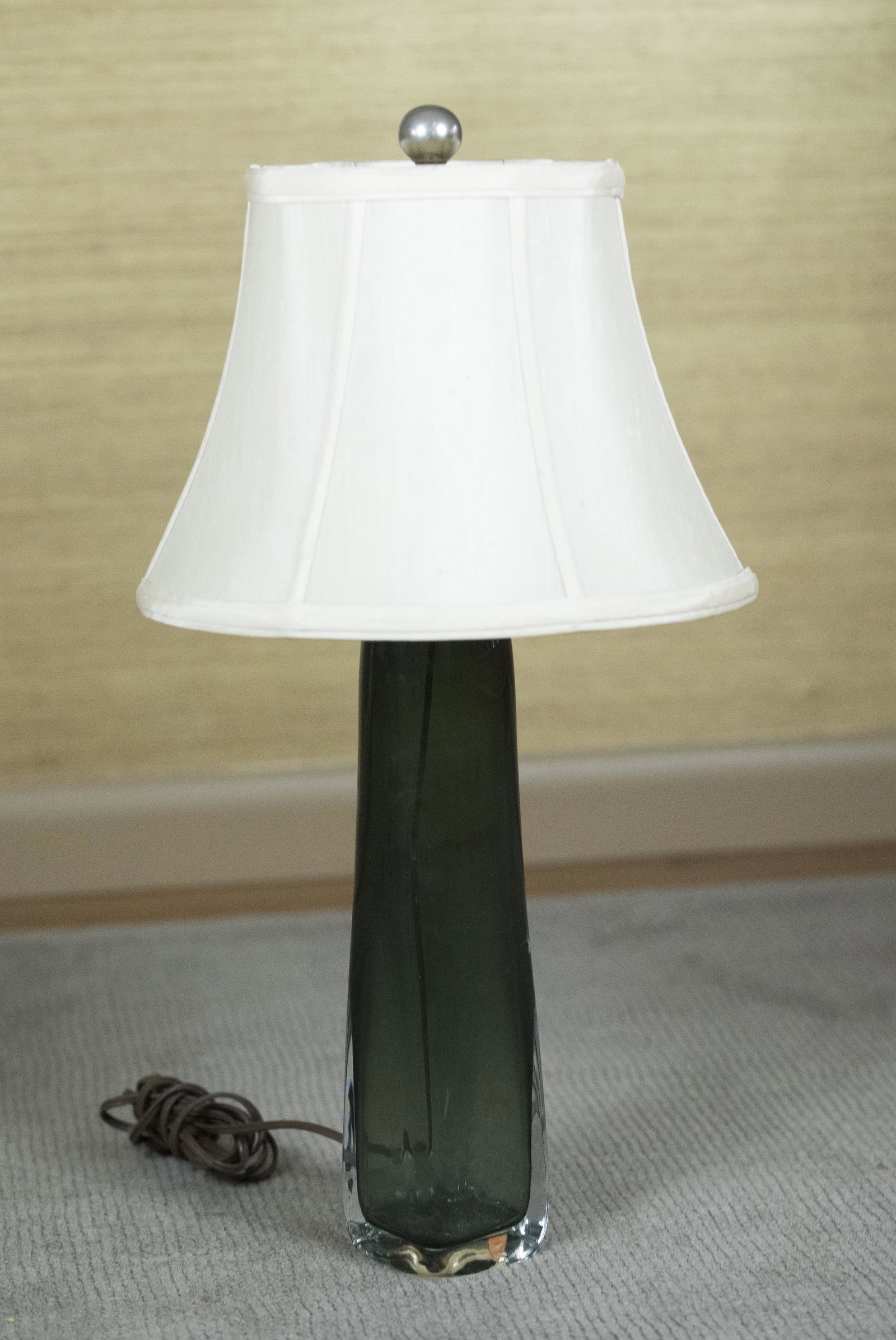 Orrefors Glass Lamp: DESCRIPTION: Orrefors green glass lamp. With paper label. With ivory colored silk shade by Grabell of California. MEASUREMENTS: Vase 13-1/4" high. Overall 23-1/2" high. CONDITION: No defects noted.