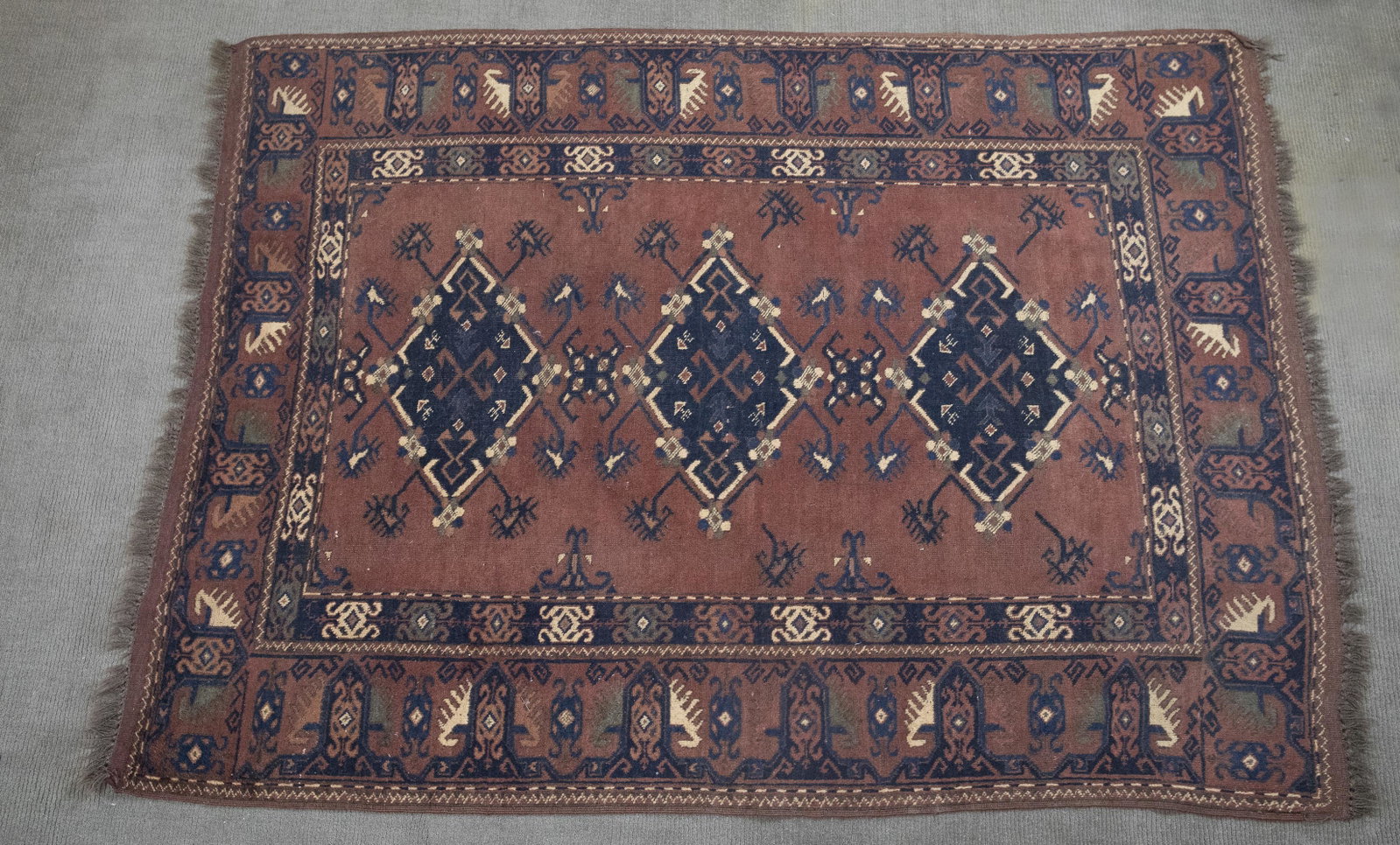 Afghan Area Rug: DESCRIPTION: Afghan area rug. 1970's. Blue medallions on red ground. MEASUREMENTS: 6'7" x 4'10". CONDITION: Light overall wear.