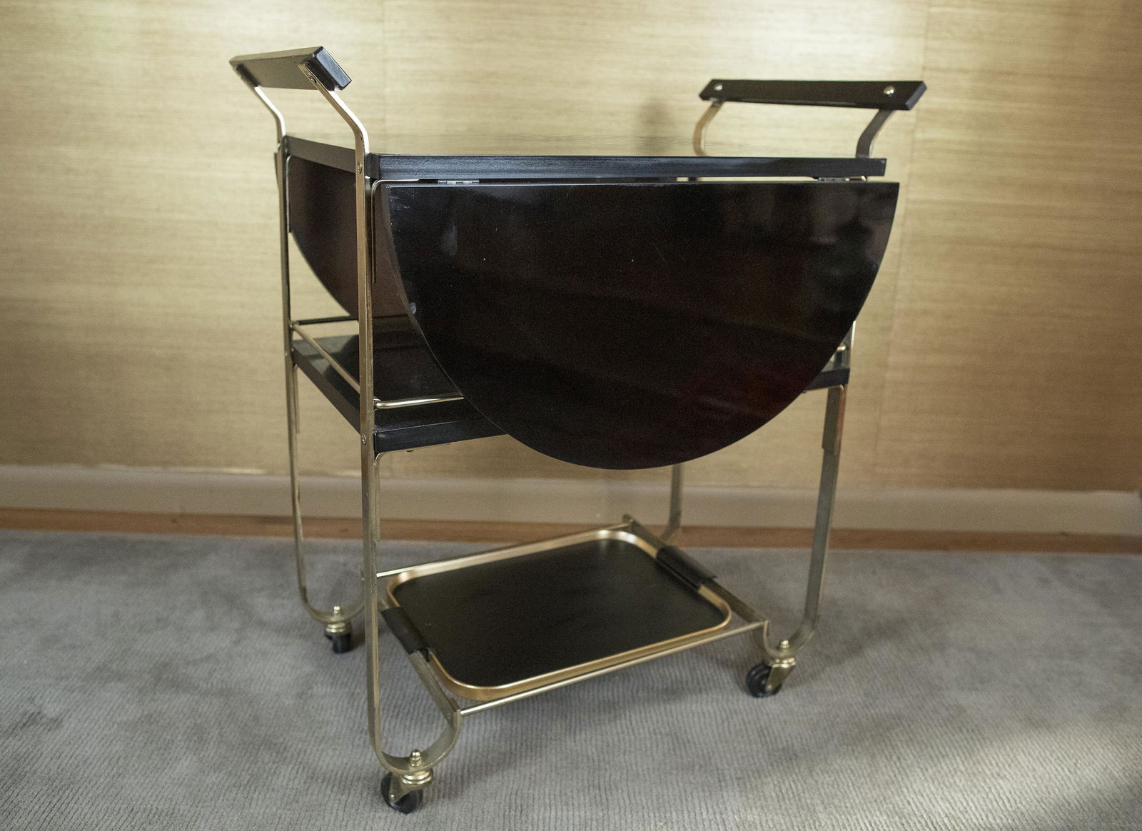 Bakelite & Brass Tea Cart: DESCRIPTION: Two shelf bakelite and brass tea cart with removable tray. MEASUREMENTS: 28-1/2" wide x 18-1/2" deep x 32-1/2" high. CONDITION: No defects noted.