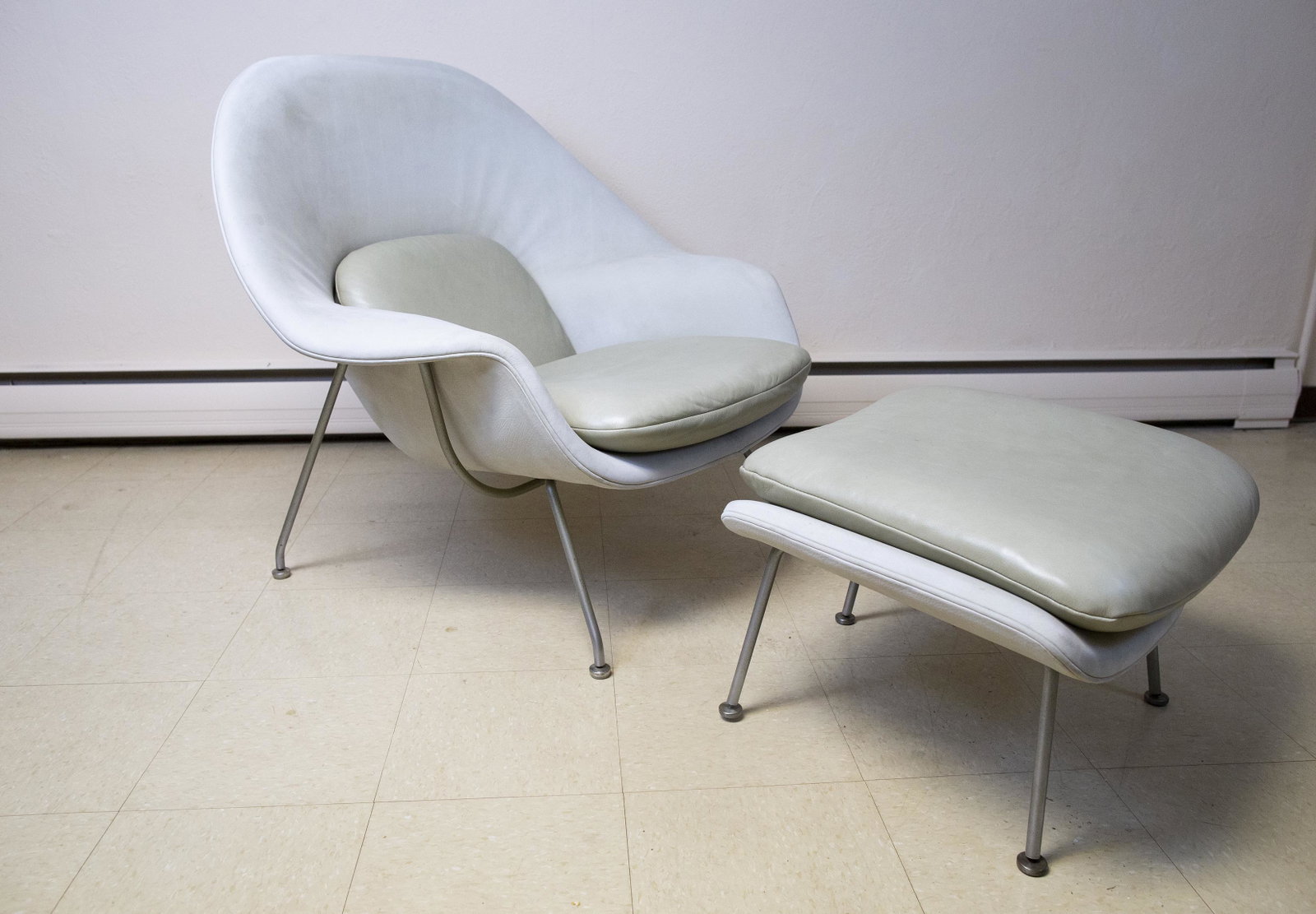 Aero Saarinen Womb Chair with Ottoman: DESCRIPTION: Ereo Saarinen for Knoll womb chair with ottoman. Cream colored leather and brushed chrome legs. MEASUREMENTS: Chair 39" wide x 35" deep x 36" high. CONDITION: Reupholstered. Light surface
