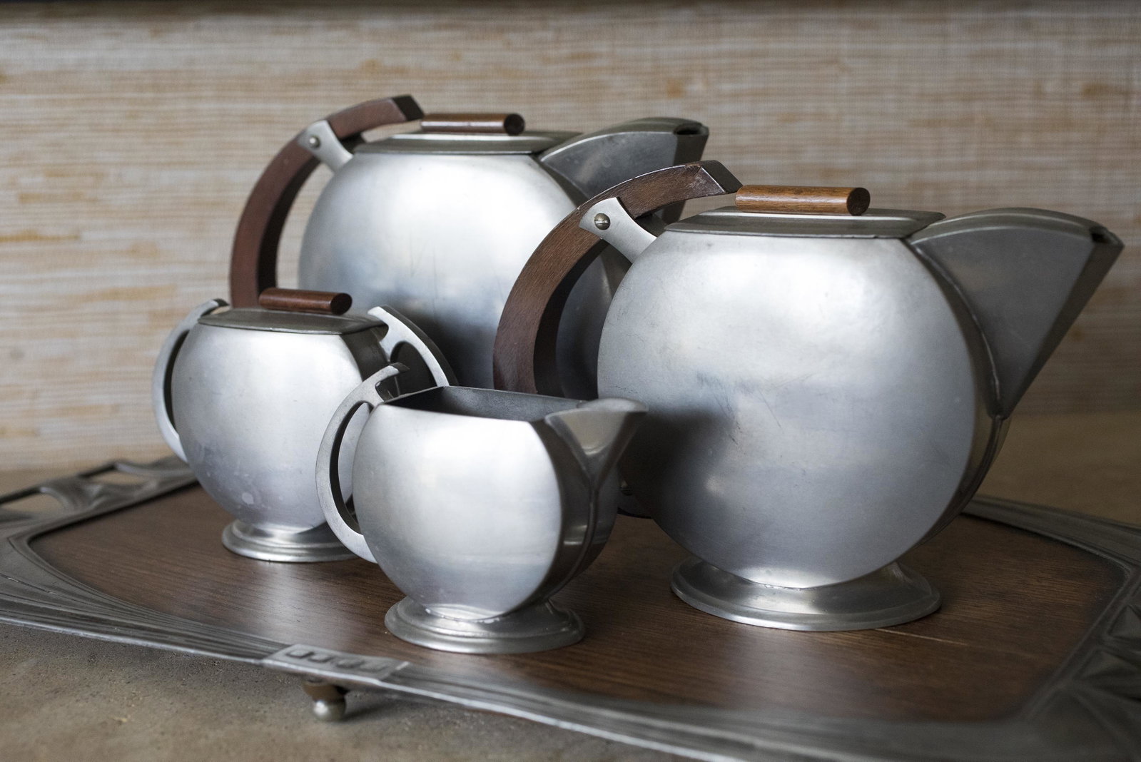 5 Pc Art Nouveau Pewter Tea Set: DESCRIPTION: Five piece Art Nouveau pewter tea set. Made in Holland by Zeister. Includes coffee pot, tea pot, cream, sugar, and tray. MEASUREMENTS: Tray: 20" x 10-1/2". Coffee pot: 6" high. CONDITION: