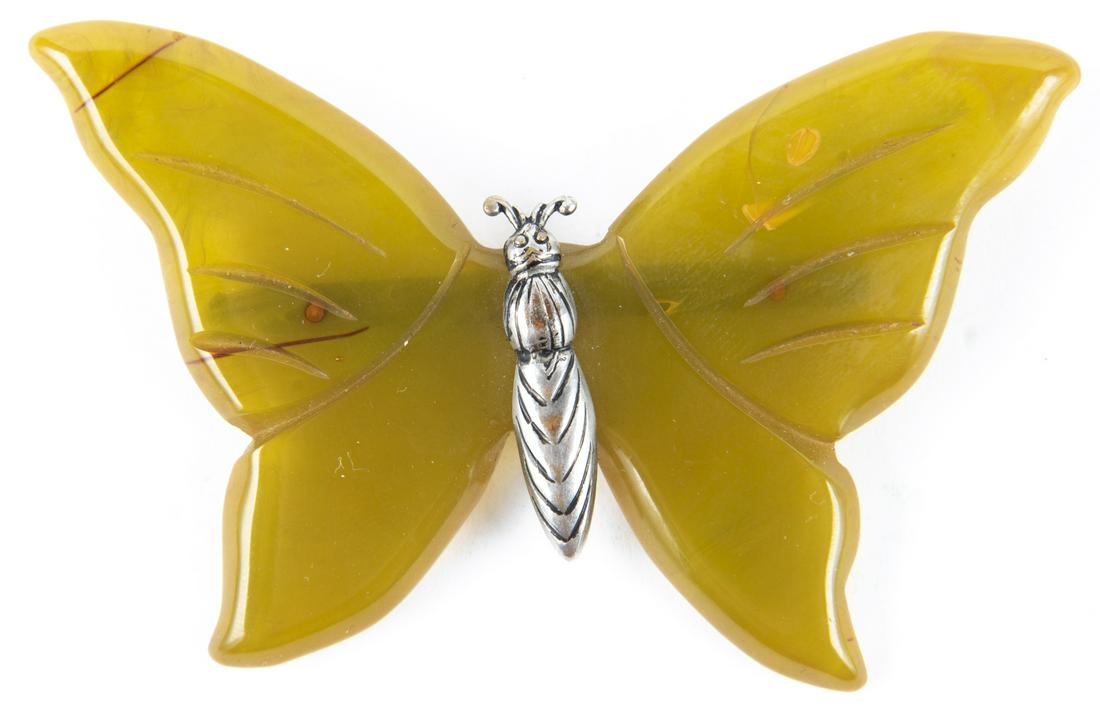 Bakelite Butterfly Pin: DESCRIPTION: Butterfly pin with Bakelite wings and silver body. MEASUREMENTS: 3" x 2". CONDITION: Light wear.