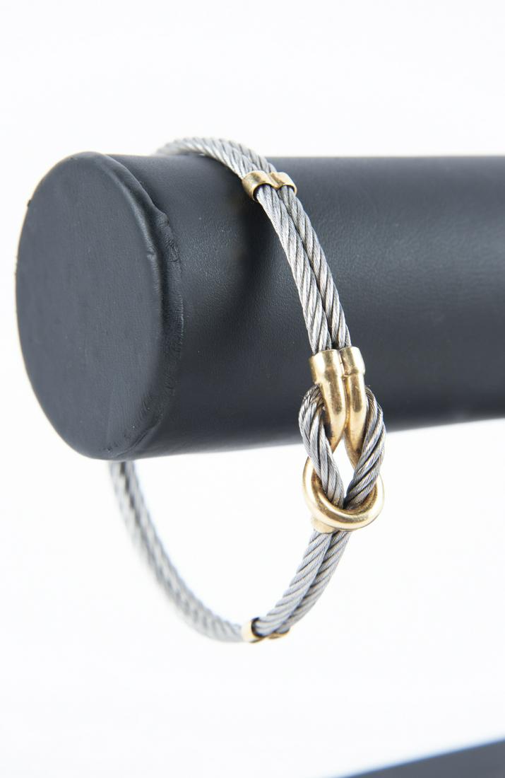 Charriol 18k Cable Bracelet: DESCRIPTION: Philippe Charriol 18k cable bracelet. Marked 750 with Charriol maker's mark. MEASUREMENTS: Interior 2-3/4", top 3/8". CONDITION: Light wear.