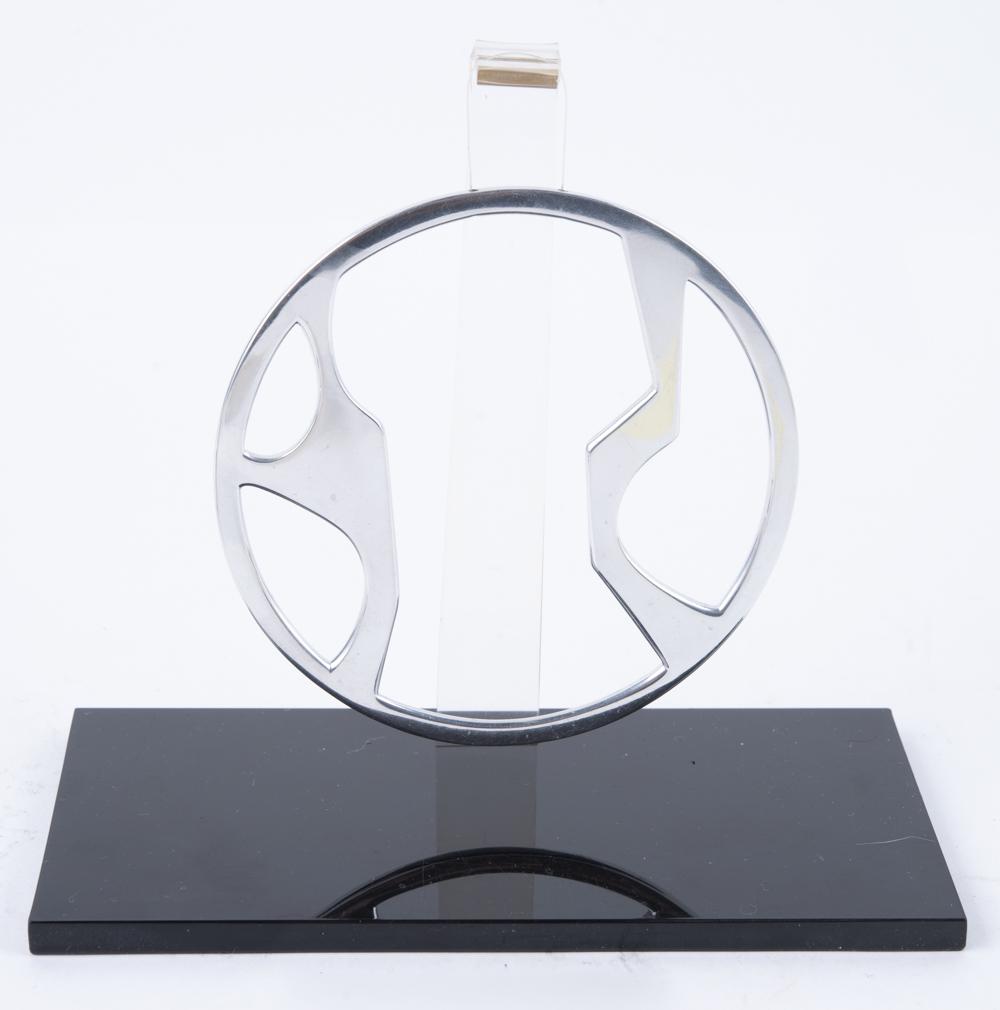 Phyllis Mark Sculpture to Wear: DESCRIPTION: Phyllis Mark sculpture-to-wear. Titled "Kinetic Circle", number 20 of 250. Signed "Phyllis Mark '71". Includes display stand, necklace, original box and paperwork. MEASUREMENTS: 3-3/4" di