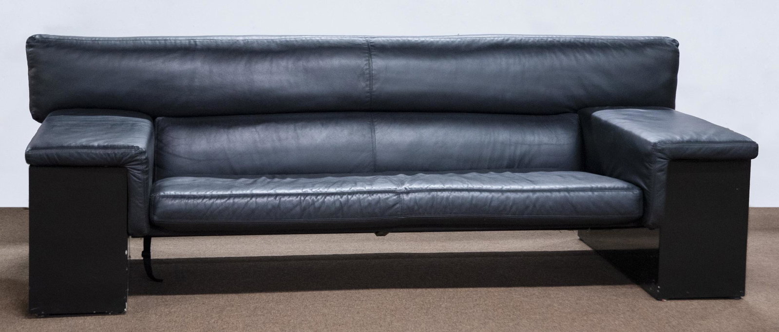 Modern Black Leather Sofa: DESCRIPTION: Modern black leather sofa. Removable cushions. Per the consigner, this sofa once belonged to Whoopi Goldberg. MEASUREMENTS: 90" wide x 36" deep x 31" high. CONDITION: Very good. Scuffs to