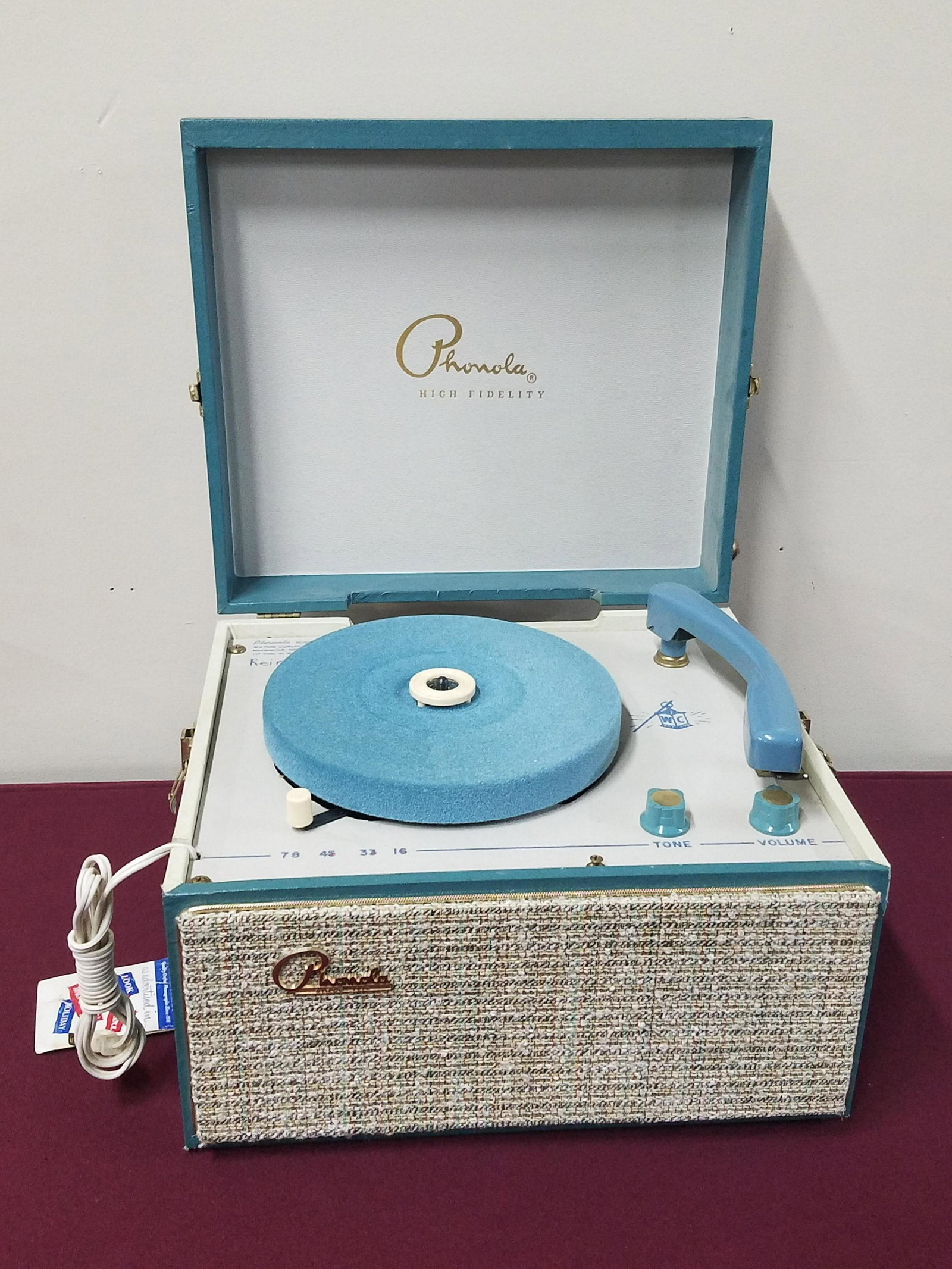 Phonola Record Player: Model number 657. 117 volts. 45 Watts. AC only. 13-3/4" wide x 12" deep x 8-1/4" high. In working order.