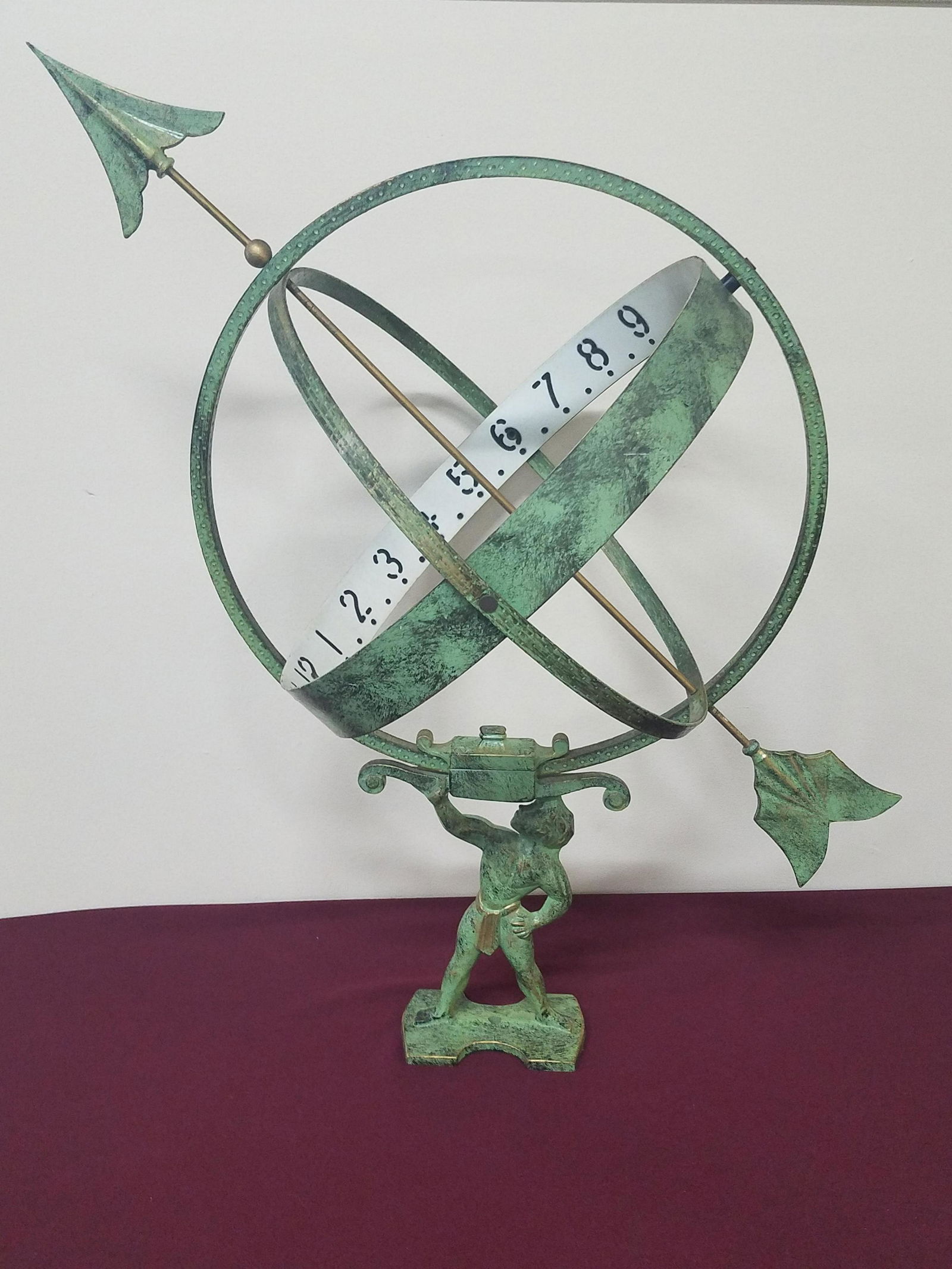 Figural Sundial: 21" wide x 16" deep x 29-1/2" high. Made of cast iron.