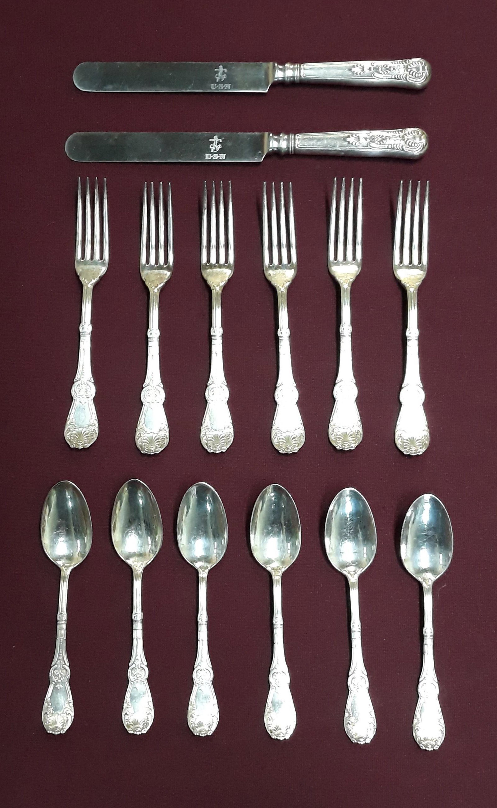 USN Cutlery with Additional Flatware: Includes two hollow handles knives in the Kings pattern, six William Roger forks, and six William Roger teaspoons.