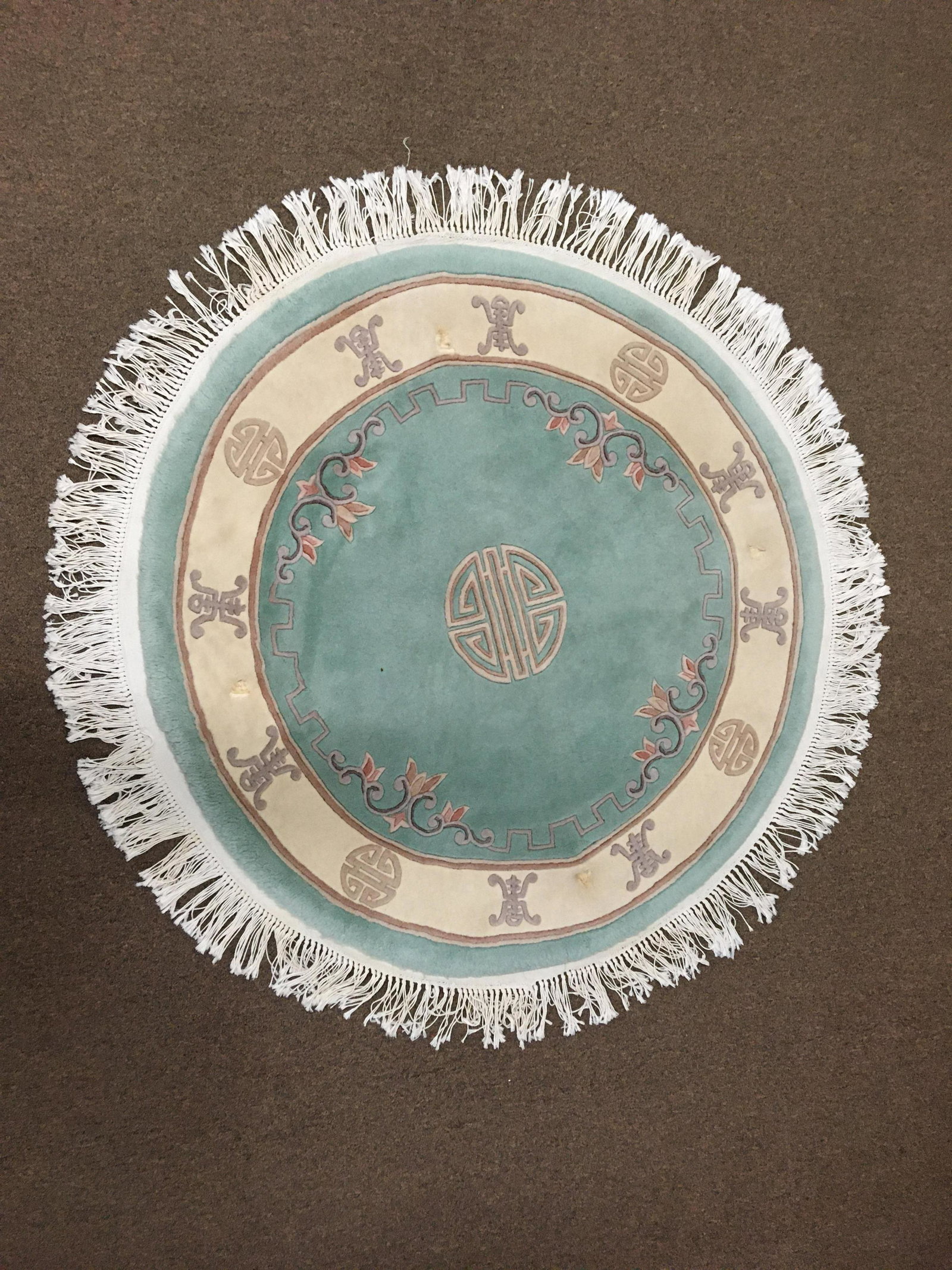Oriental Area Rug: 51" diameter. Some discoloration and furniture impressions.