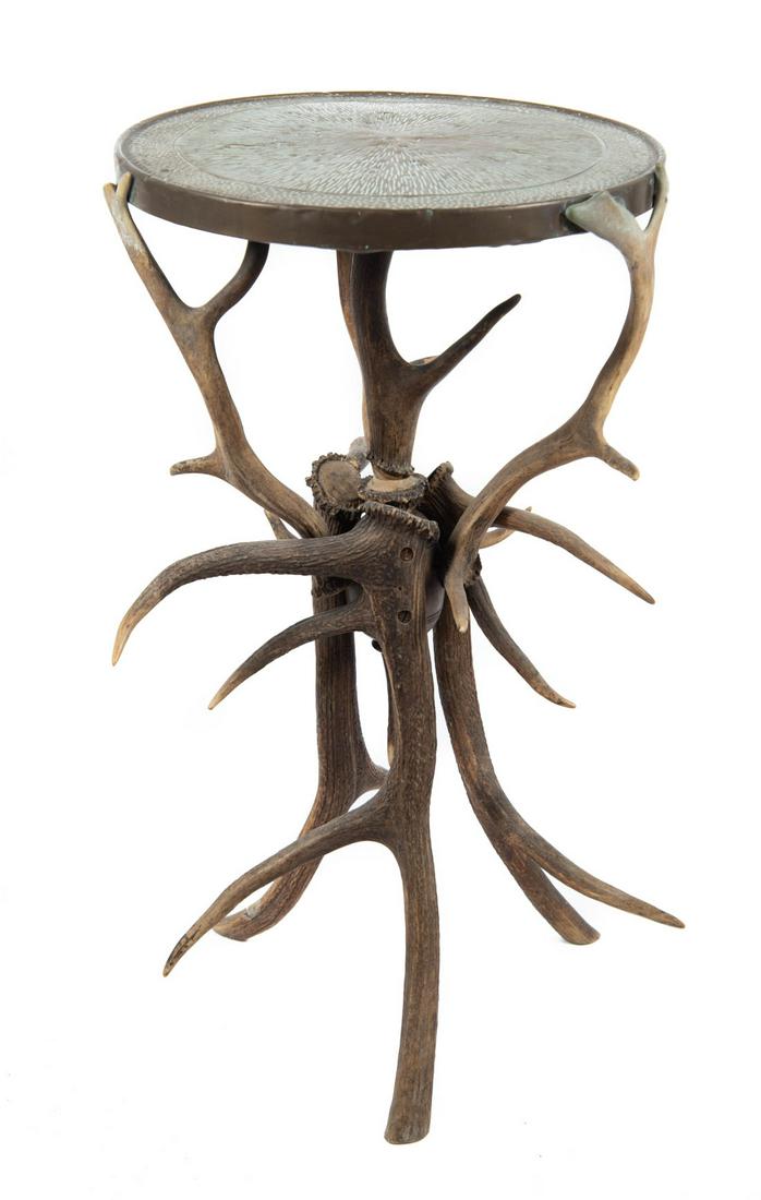 19th C. Rustic Antler & Pressed Brass Side Table: DESCRIPTION: 19th century rustic side table with circular wood table topped with brass surmounting eight piece antler horn base. Unsigned. MEASUREMENTS: 15-1/2" diameter x 27-3/4" high. CONDITION: Lig