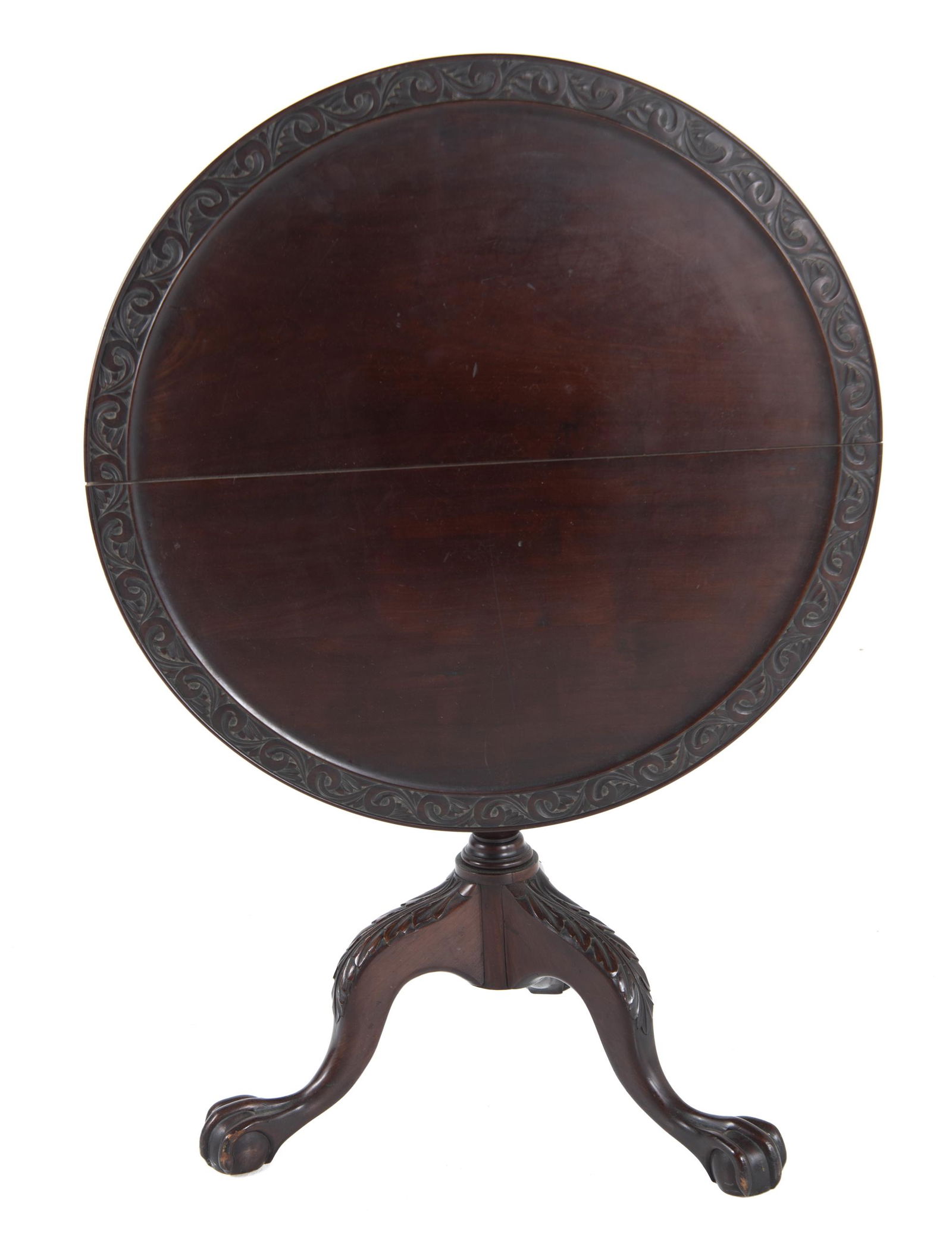 Tilt Top Tea Table: DESCRIPTION: Tilt top tea table. With carved swirling decorated border to table top and claw and ball feet. MEASUREMENTS: 28-1/2" diameter x 27-1/2" high. CONDITION: Light surface wear.